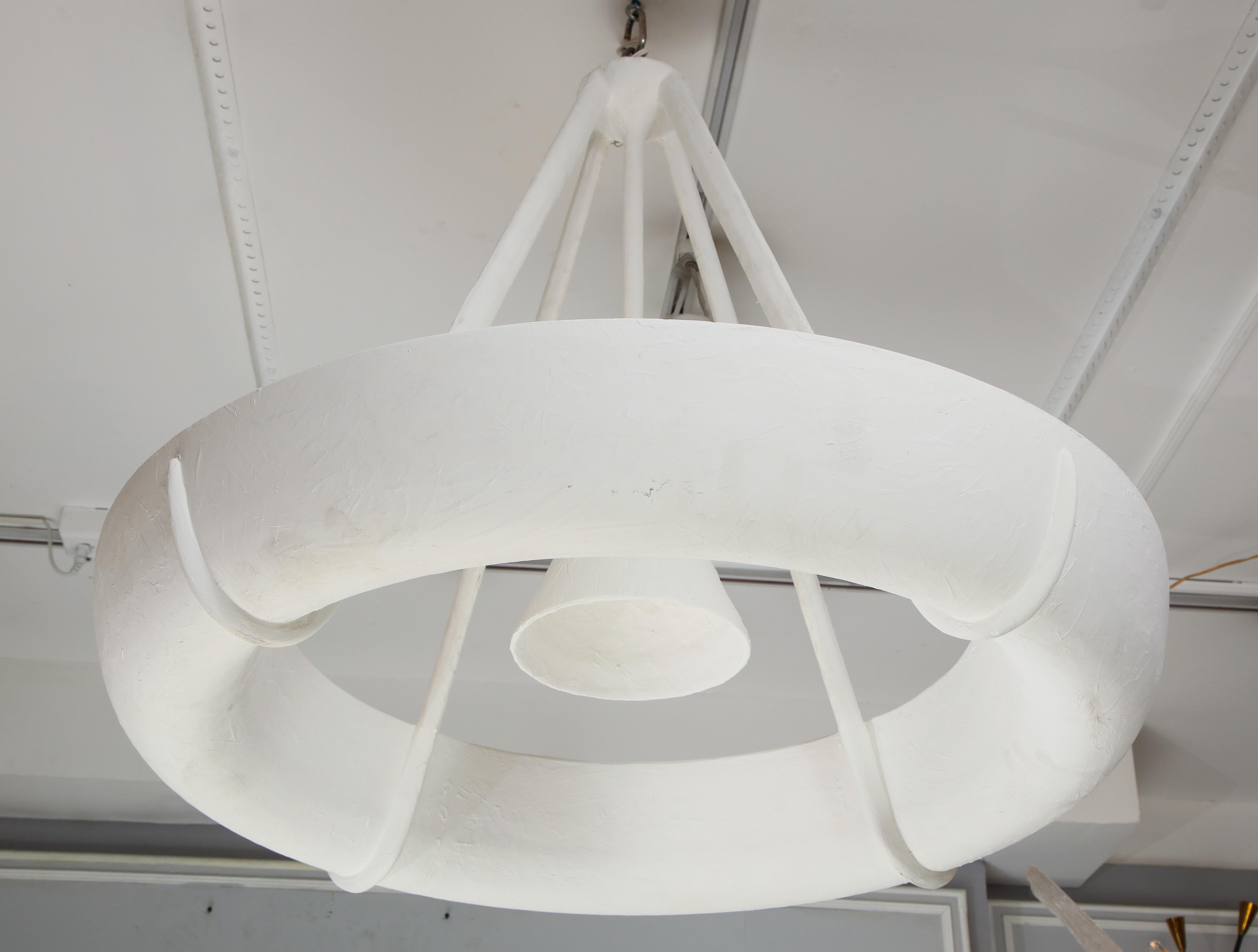 Sculptural bespoke Neve plaster fixture in the Jean Michel Frank manner.
Please note that this fixture takes (1) Edison bulb at 40 or 60 watts in the center and (8) e-12 candelabra bulbs at 40 watts each in the interior. = 320 watts inside ring. 