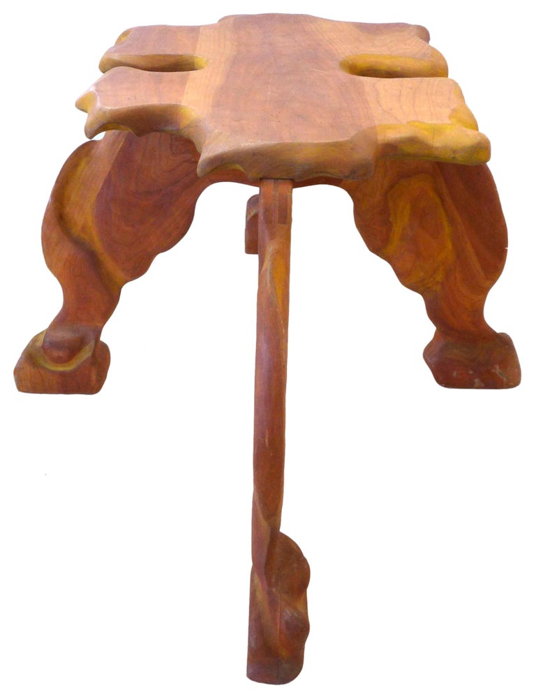 An incredible and unusual biomorphic carved wood side table.  A comparatively petite, jaggedly undulating top with ample, exaggeratedly splayed legs of seemingly muscular intent.  Great, impressive scale and sculptural presence.  A well executed and