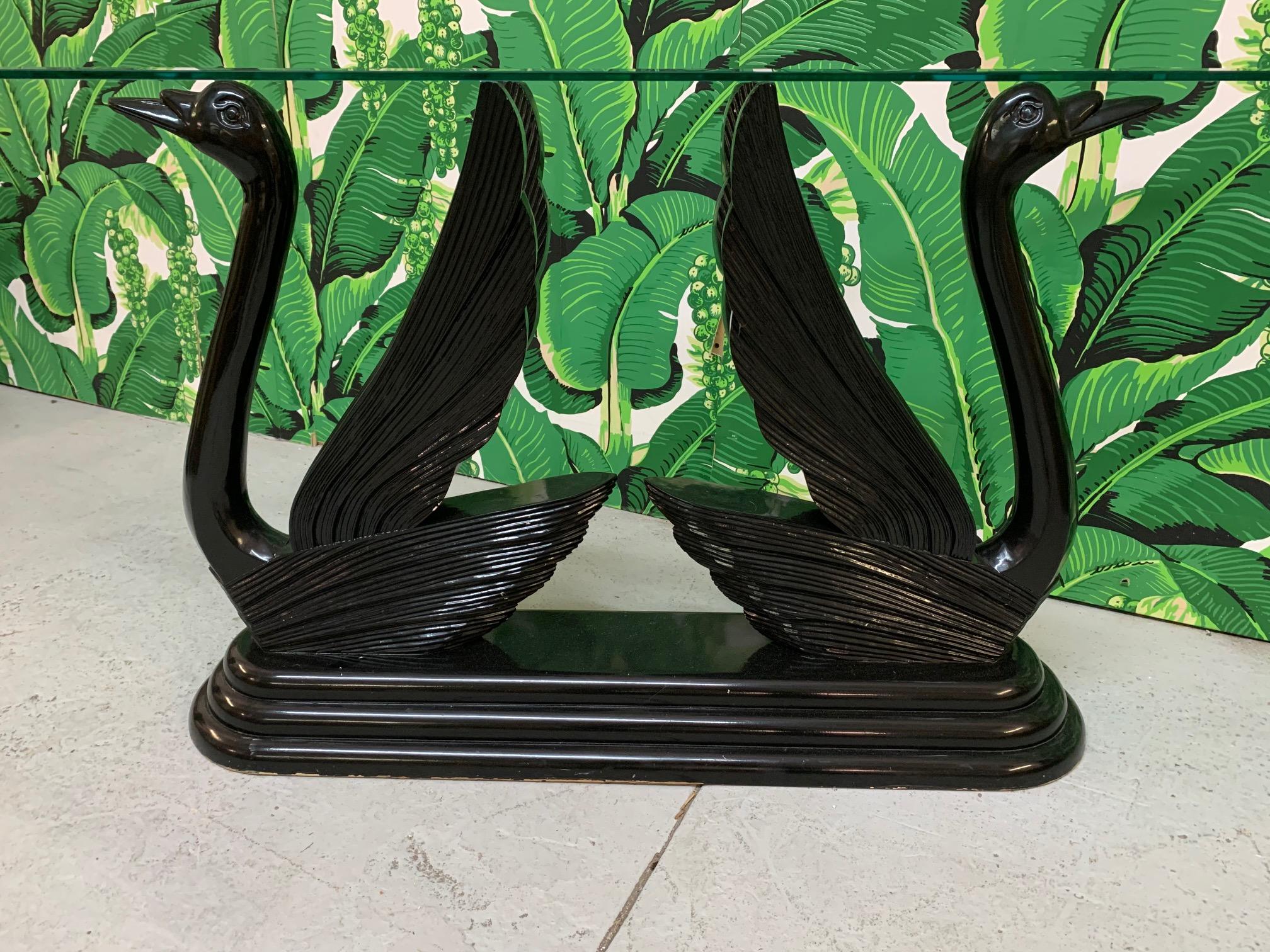 Vintage console table features sculptural swan design with opposing swans crafted from heavyweight resin. In the style of Maison Jansen. Glass top with beveled edge. Glass measures 52