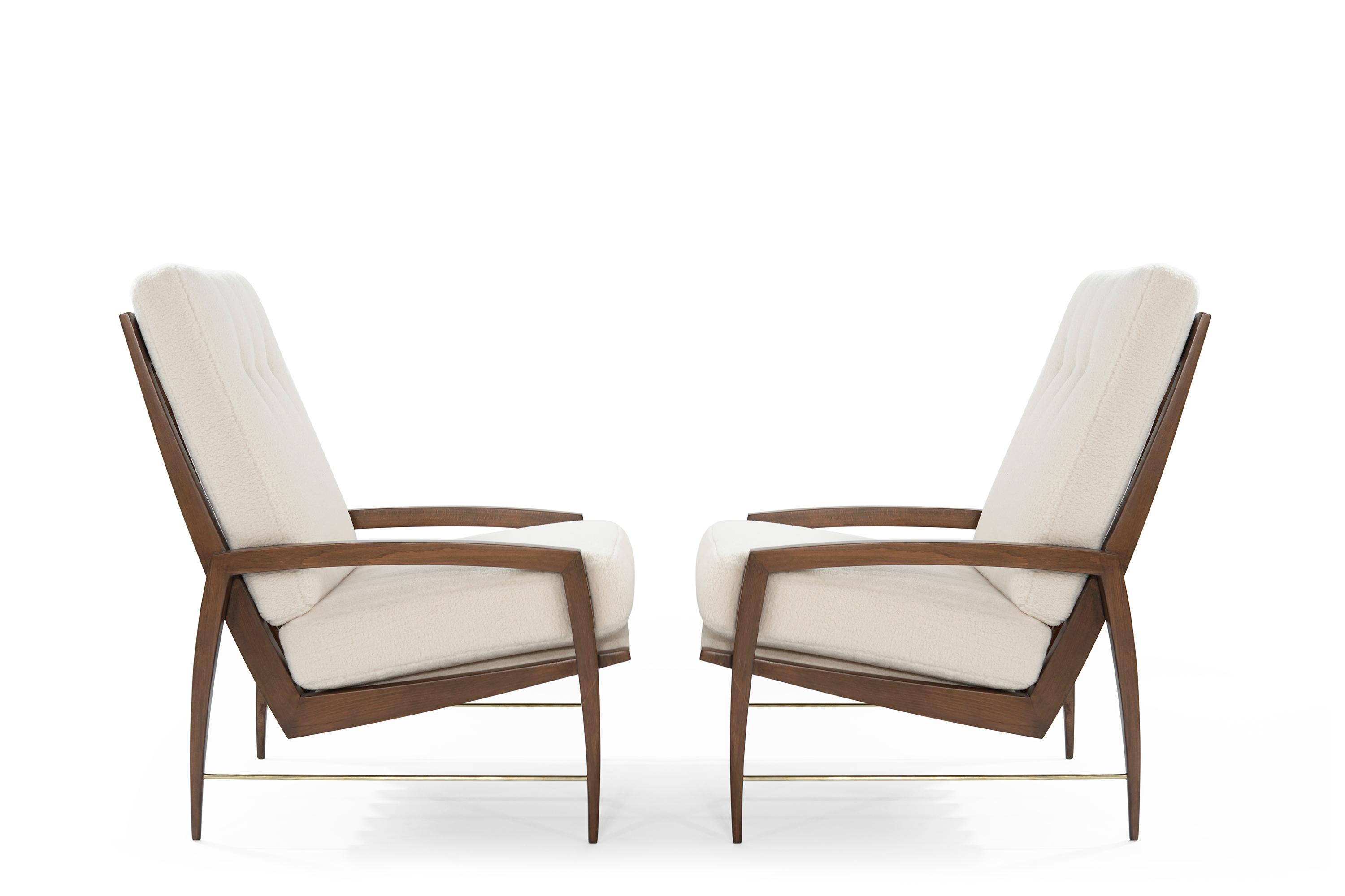 A pair of lounge chairs handcrafted from solid teak original from Denmark, circa 1950s. Teak framework fully restored back to its original finish. Newly upholstered in plush synthetic wool by Kravet. Featuring hand-polished solid brass rods.
  