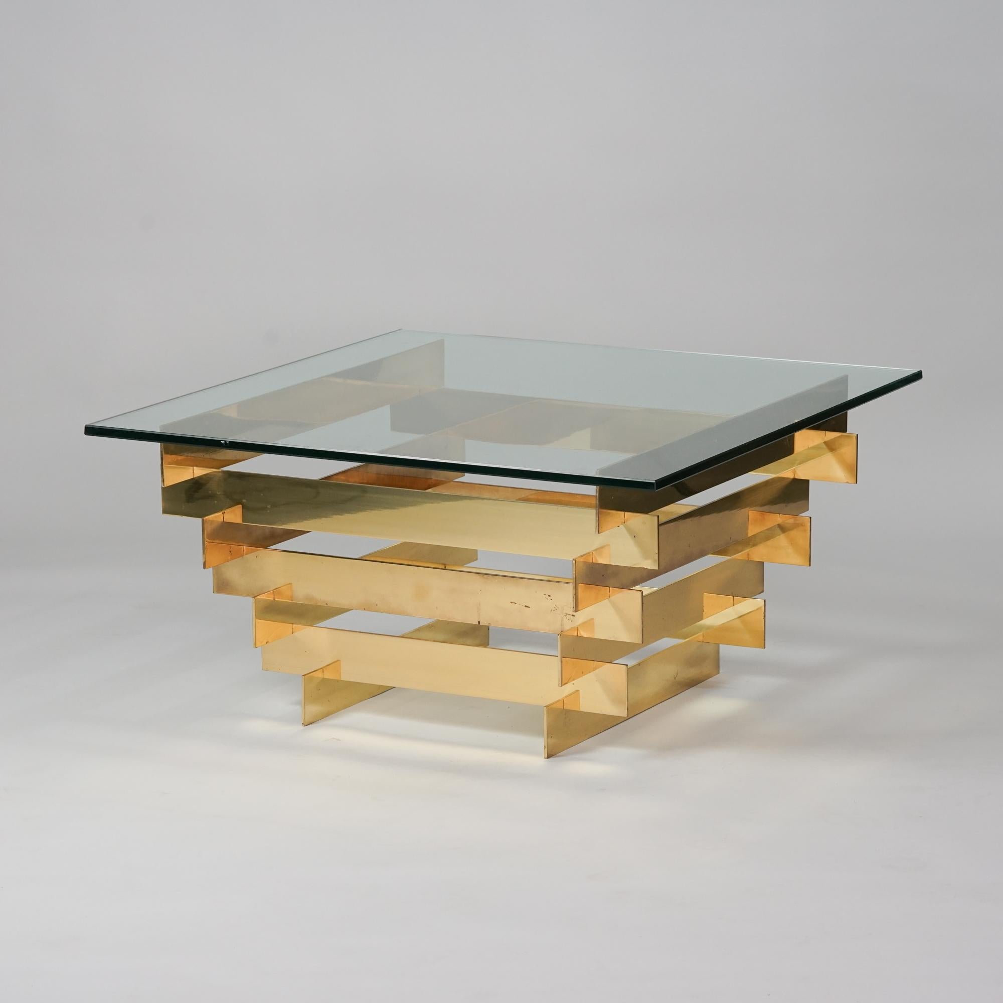 Sculptural coffee table, designed by David Hicks, 1970s. Brass frame with glass table top. Good vintage condition, minor patina consistent with age and use. Gorgeous design. 

David Nightingale Hicks, was an English interior decorator and designer,