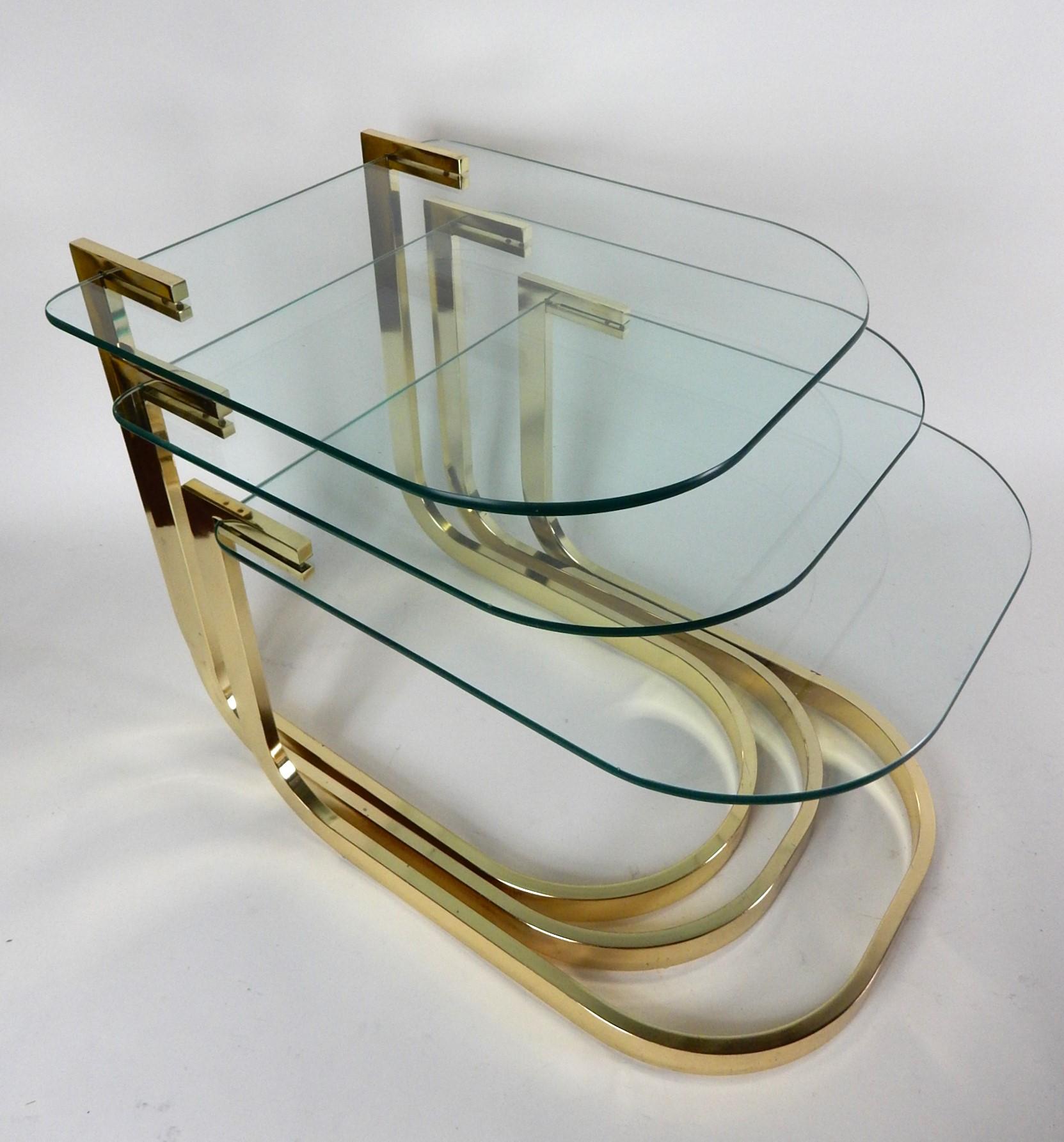 Nesting table set from the 1980's
created by The Design Institute of America.
Brass plated tubular steel frames with
cantilever glass tops.
Tops measure 21.50