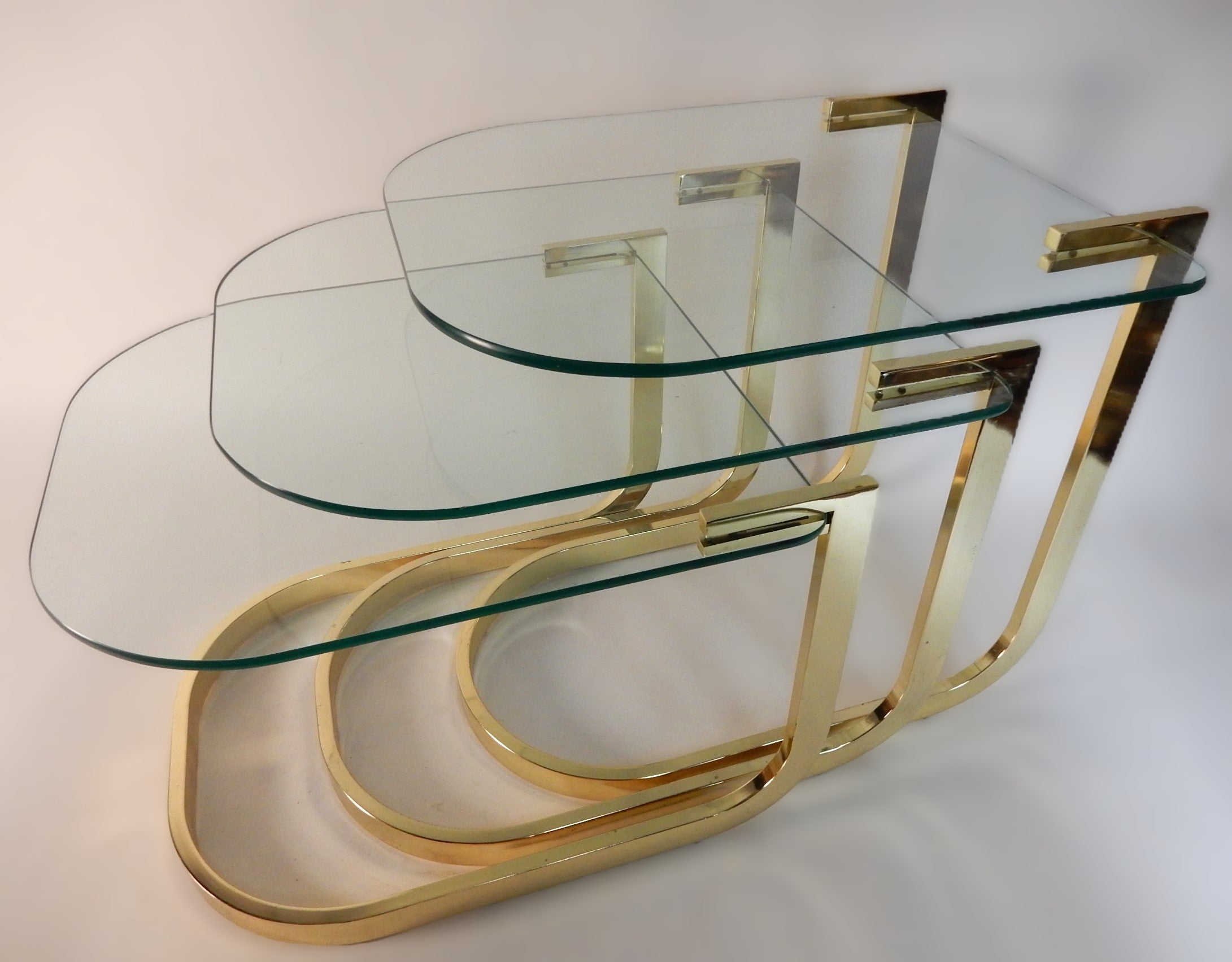 American Sculptural Brass Nesting Table Set with Cantilever Glass Tops For Sale