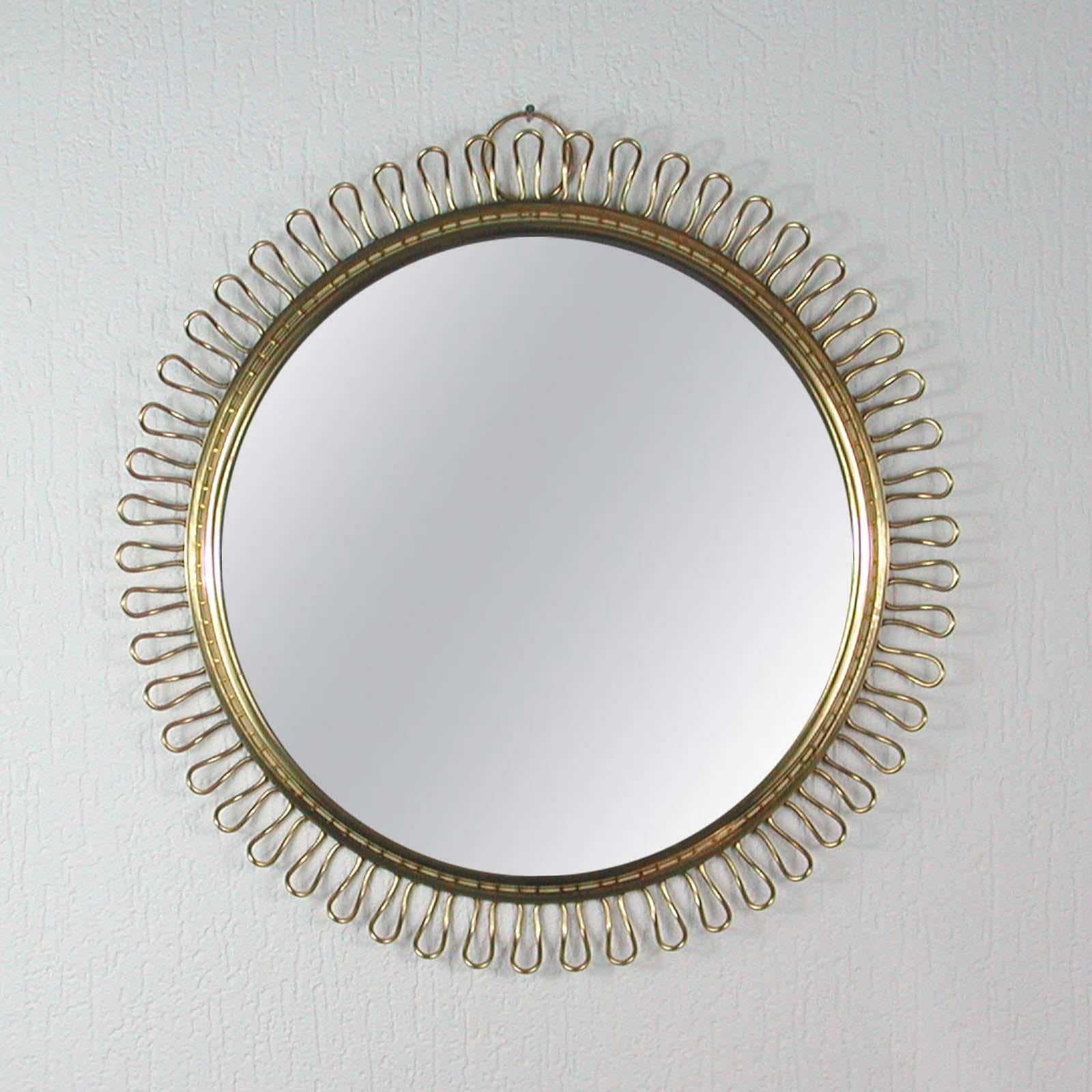 This beautiful brass loop wall mirror was designed in Sweden by Josef Frank for Svenskt Tenn in the 1950s. The brass frame with nice warm vintage patina. The mirror flawless. The rear with teak veneer.

Measures: Diameter app.: 17.8