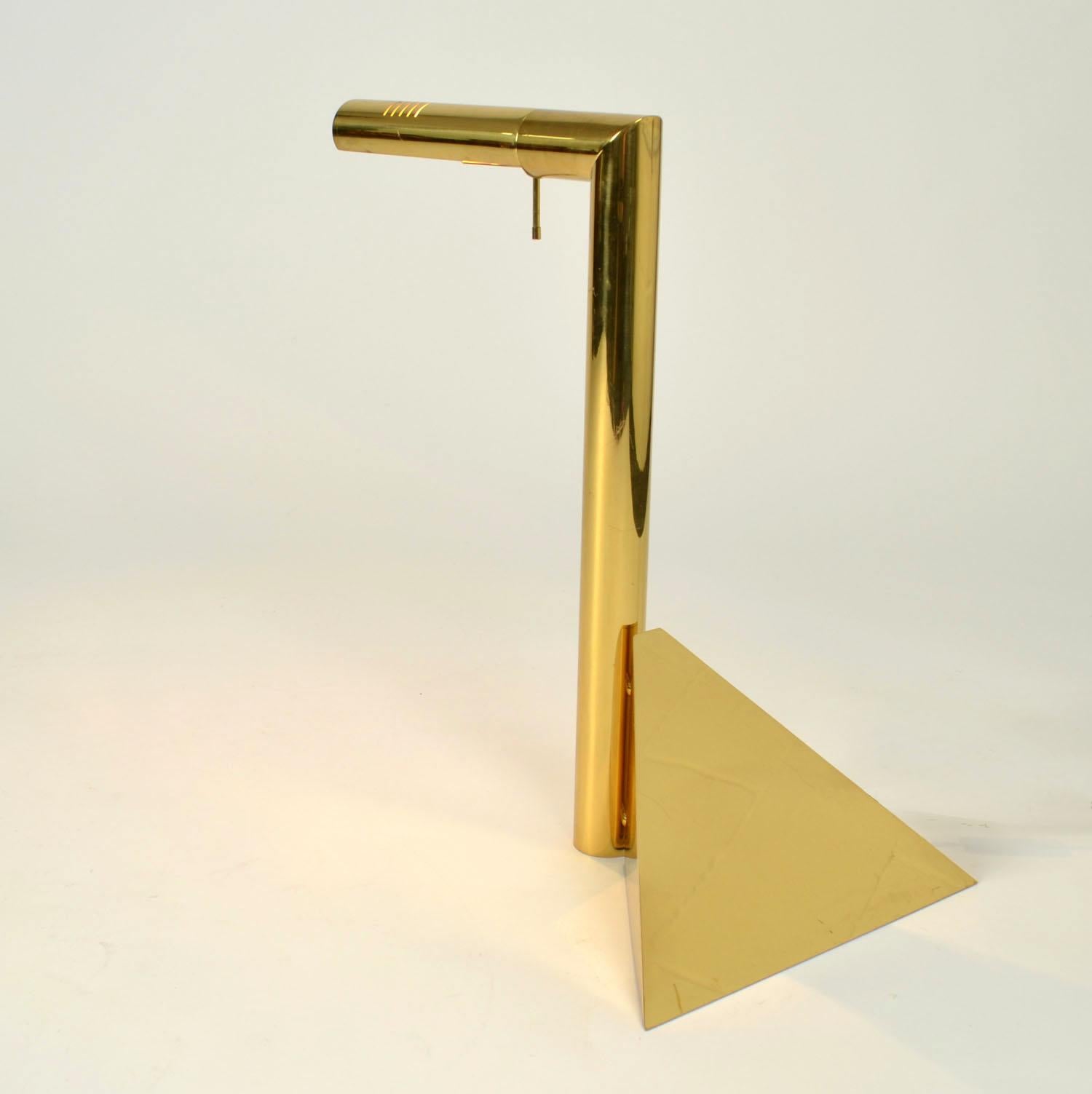 Sculptural tubular polished brass L shape table light with a pyramide shape foot and articulated ligh is designed in the 1970's in Italy. The light sourse is halogen which nowadays comes as LED light. The diffuser can be directed by a handle which