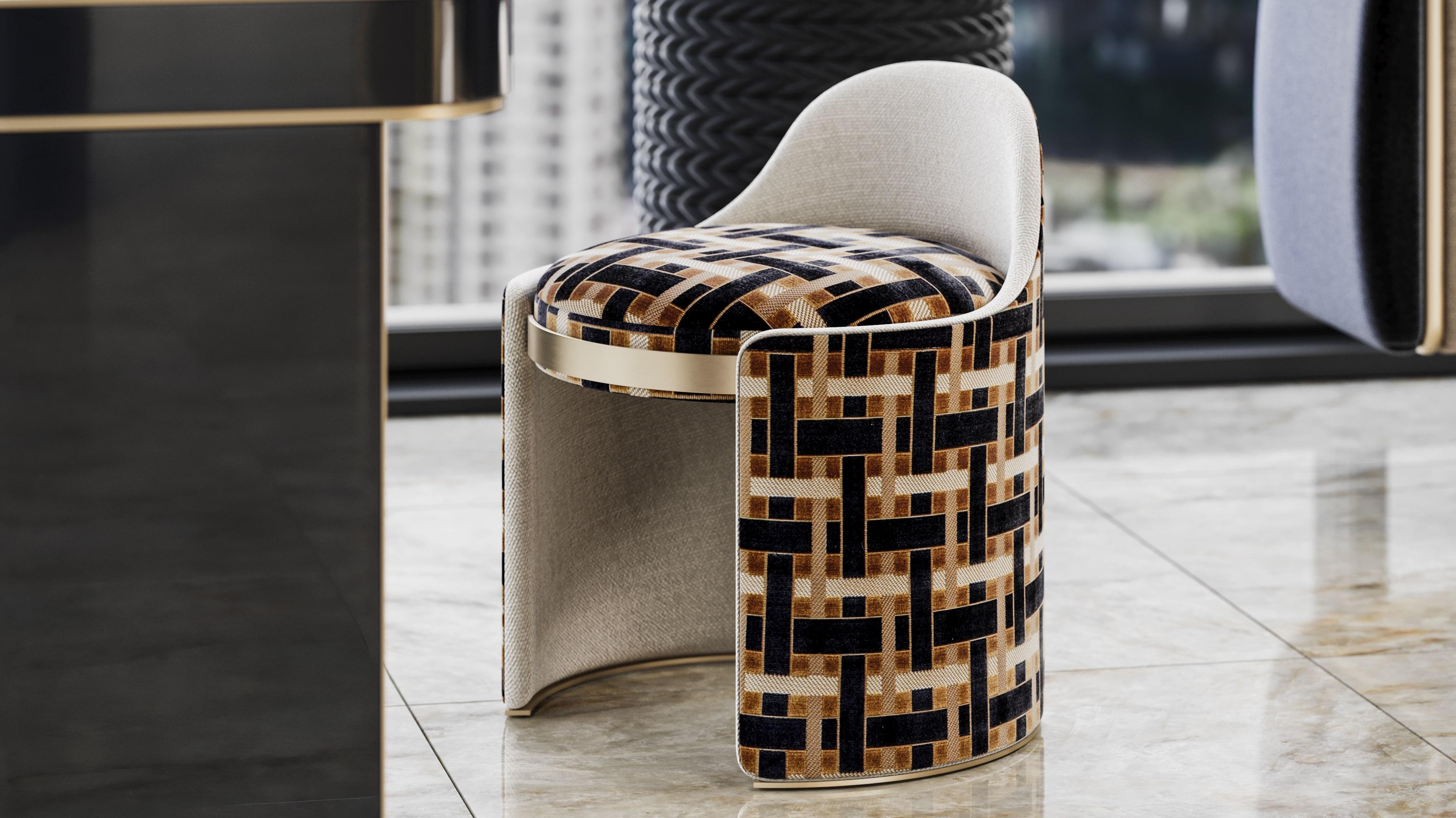 A sculptural presence in a compact form, the Brion stool exudes quiet strength and refined minimalism. Defined by its geometric profile and symmetry, Brion its upholstered in rich fabric. Its form is elevated by a meticulously detail in brass that