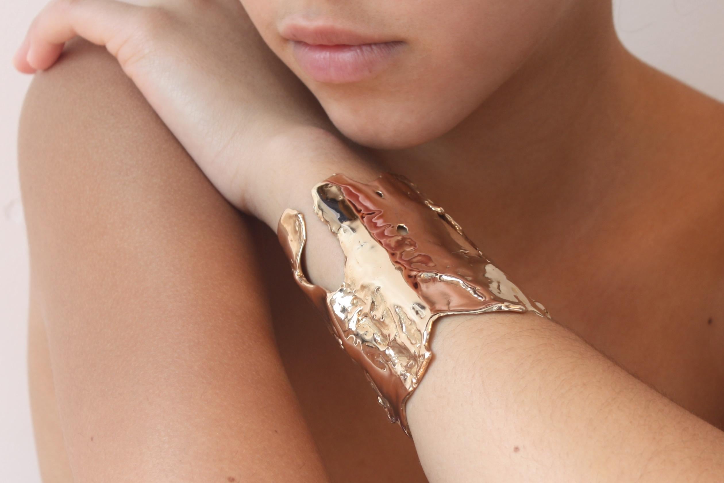 We all want to be Wonder Women. It may not stop bullets, but it will start a conversation!  
A sculptural statement, hand cast and finished in polished bronze. This bold, artistic cuff bracelet fits a medium to small wrist. Approximately