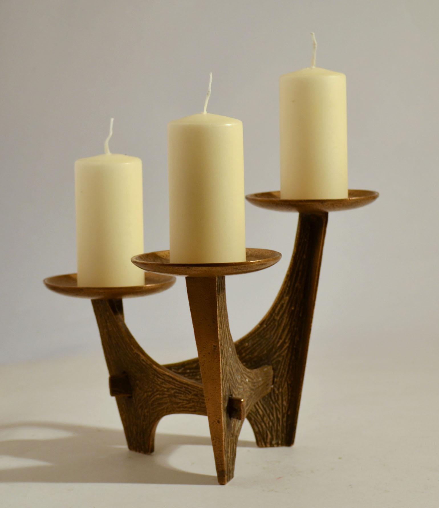 Freeform bronze cast candelabra has three alternating candle holders that can hold candles up to 6 cm diameter with a scratched texture.
It will make great sculptural decoration for the festive season.