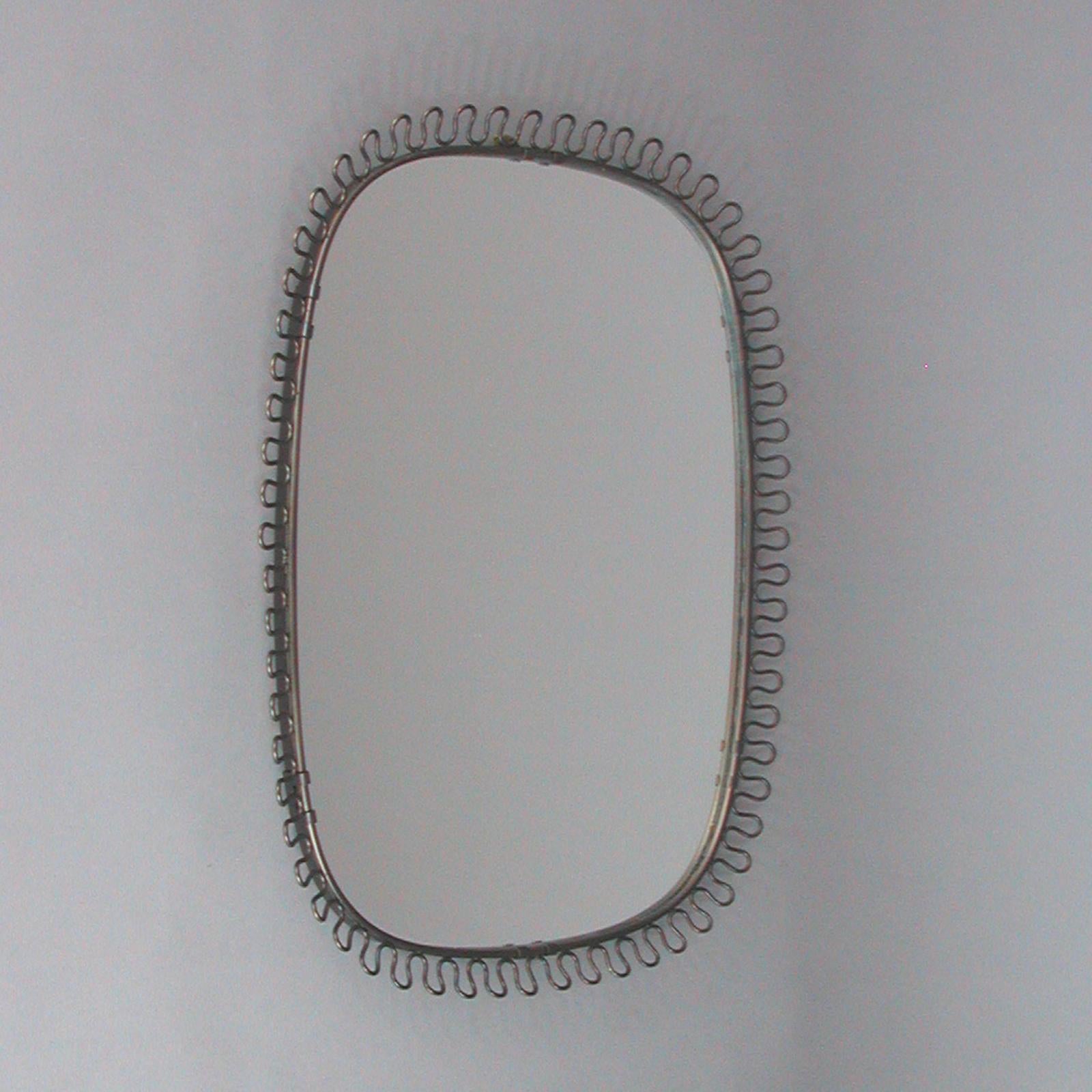 This beautiful sculptural loop wall mirror was designed in Sweden by Josef Frank for Svenskt Tenn in the 1950s. The bronzed frame with nice warm vintage patina. 

The original mirror glass flawless.
Size of mirror glass only: 16.5