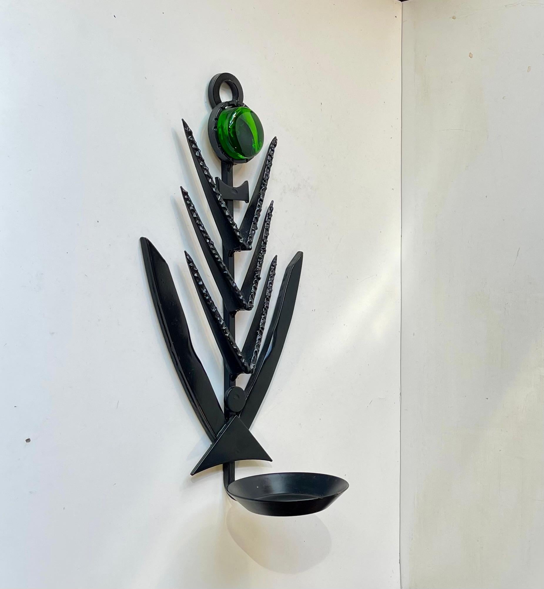 1970s Brutalist Wall candle sculpture made by Danish design company Dantoft kunstartikler (trans.: art objects). Made from black lacquered and welded iron set in a graphic formation highlighted by a thick green glass mosaic. It can be installed with