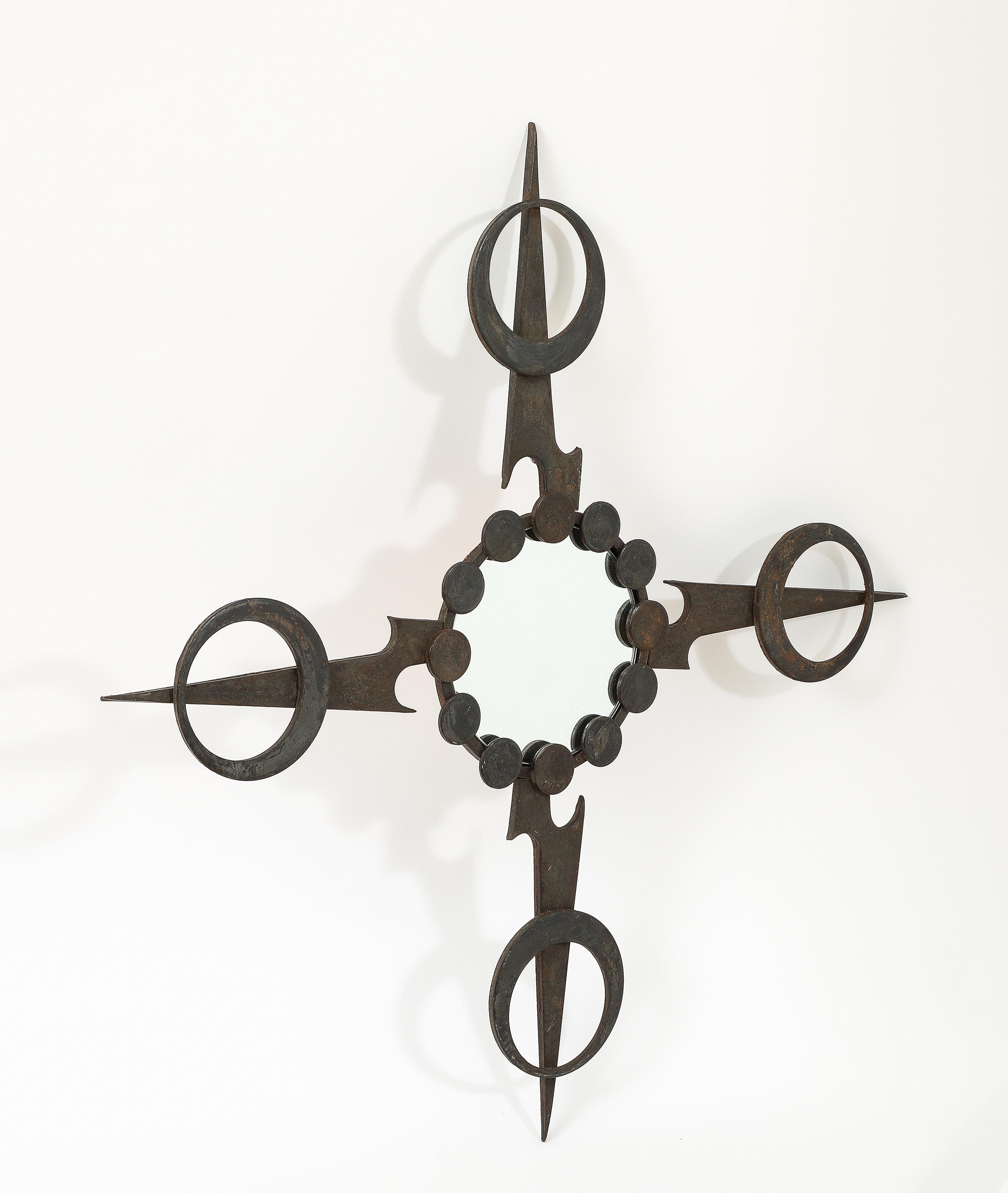 Graphic welded brutalist wrought iron mirror in the shape of a star. France, 1970's.
Patina on all surfaces.