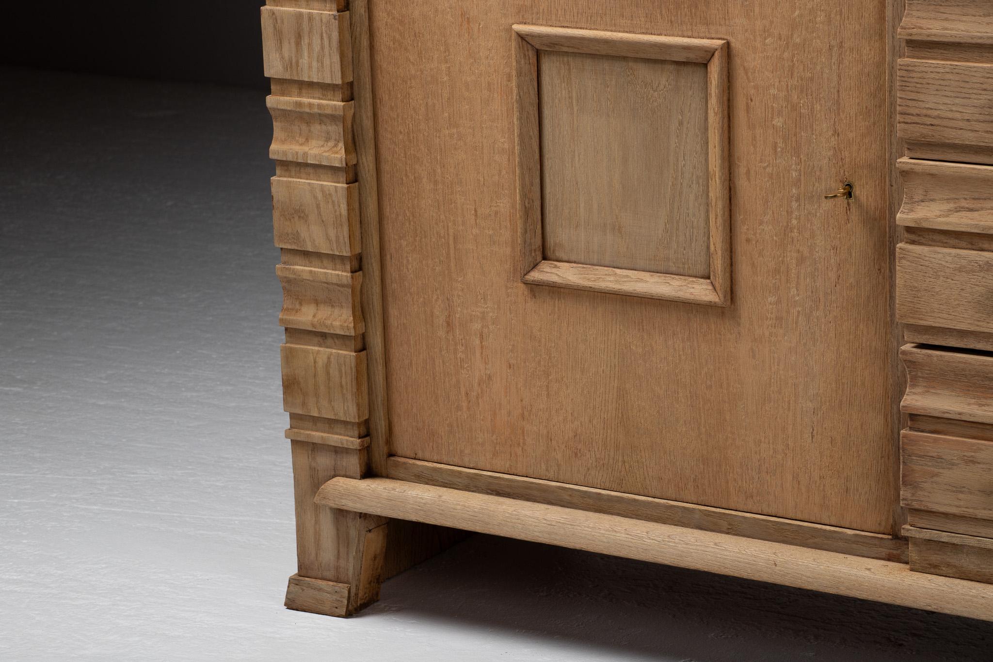 A composition of stoic elegance, this French buffet reveals a language of sculptural restraint and architectural rhythm. Framed at either end by stacked pilasters in graduated relief, the piece commands presence not through ornament but through the