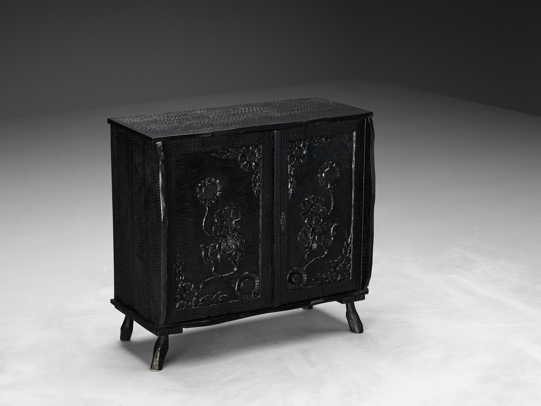 Cabinet, lacquered wood, France, 1970s

Crafted with unparalleled artistry, this large cabinet epitomizes exquisite craftsmanship with meticulously carved details that draw inspiration from nature. This design exudes an enchanting charm reminiscent