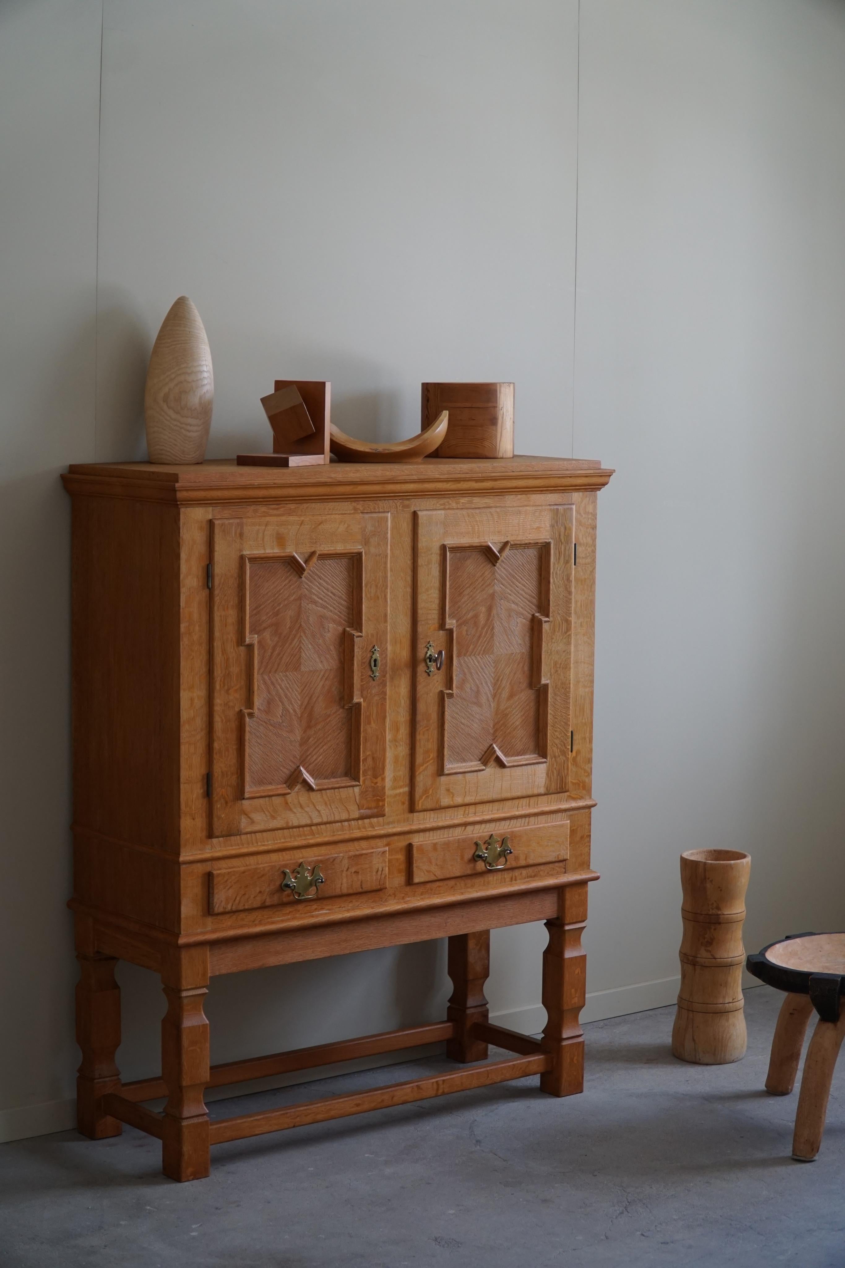 A classic sideboard / cabinet in oak with great storage space and a nice sculptural front pattern. Attributed to Henning (Henry) Kjærnulf for E.G møbler in the 1960s. 

This fine brutalist cabinet will complement many interior styles. A modern,