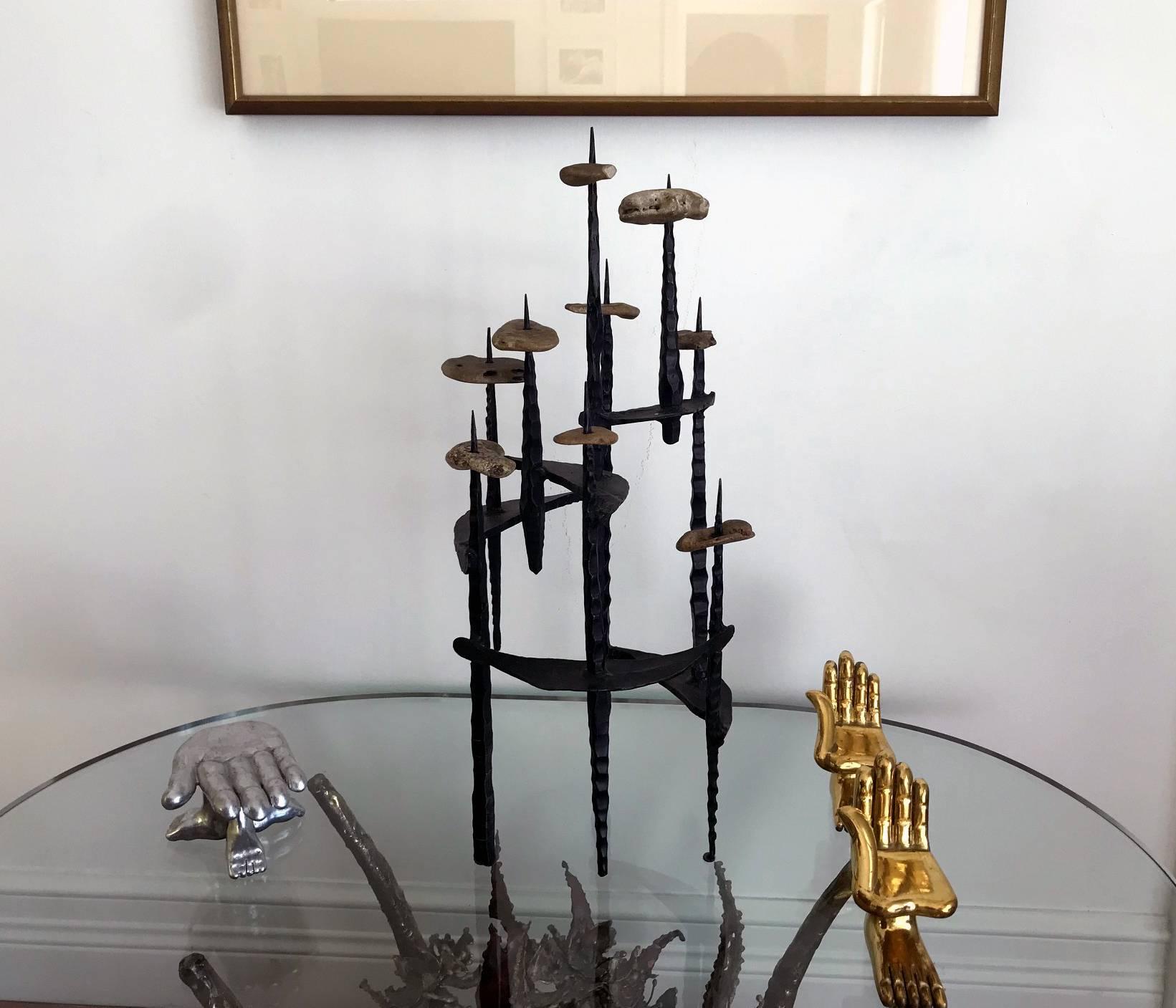 A very sculptural menorah or candelabra made with welded hammered iron and rocks by Israeli sculptor David Palombo(1920–1966). Its has a very impressive 