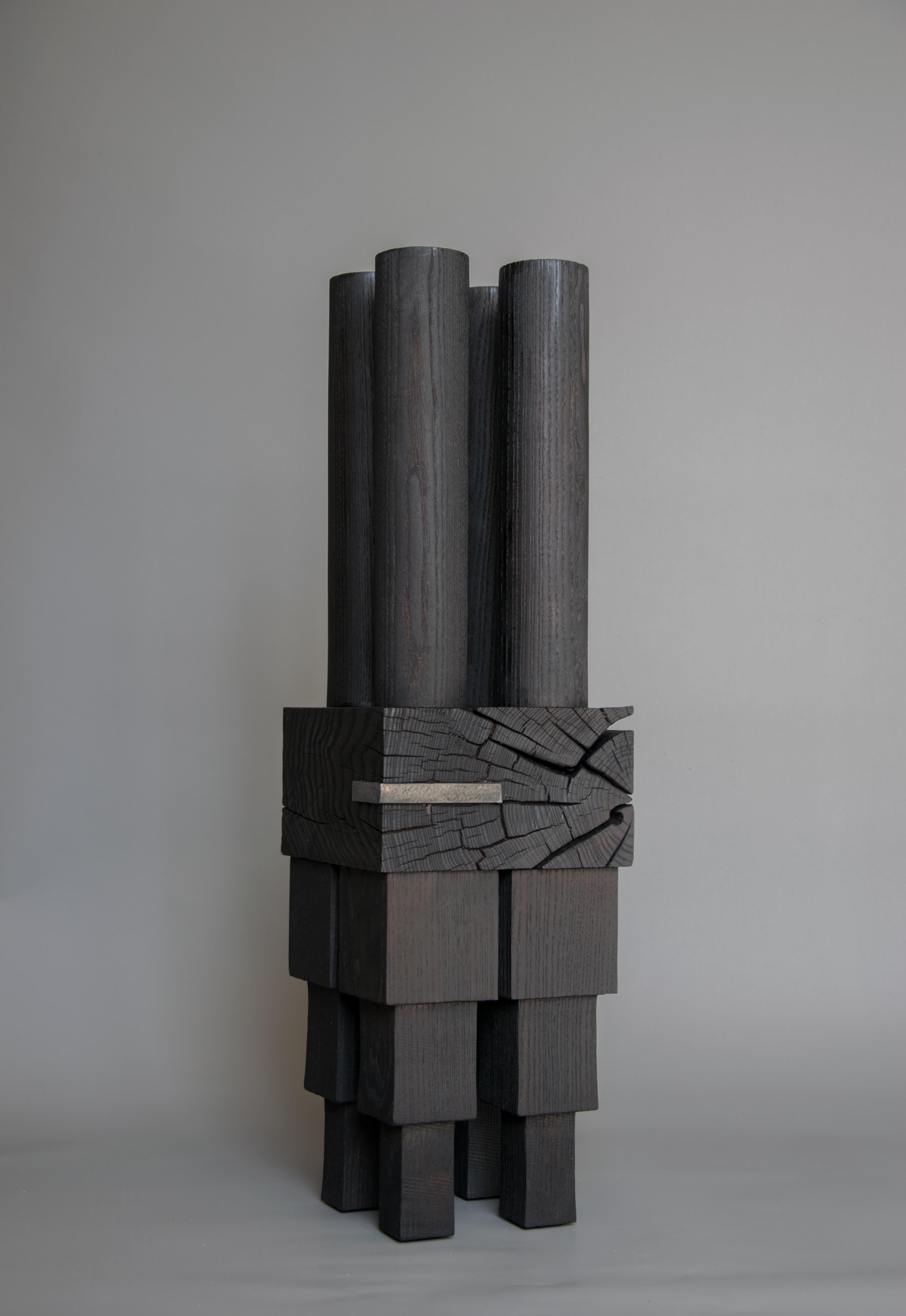 Sculptural Candle Holder by Christian Caulas
Unique piece
Materials: Burnt Ash, Linseed oil finish 
Dimensions: W 19 x H 67 cm

Woodturning and Assembly Candle Holder in Burnt Ash.

It was in 2013 that Christian Caulas created his first collection