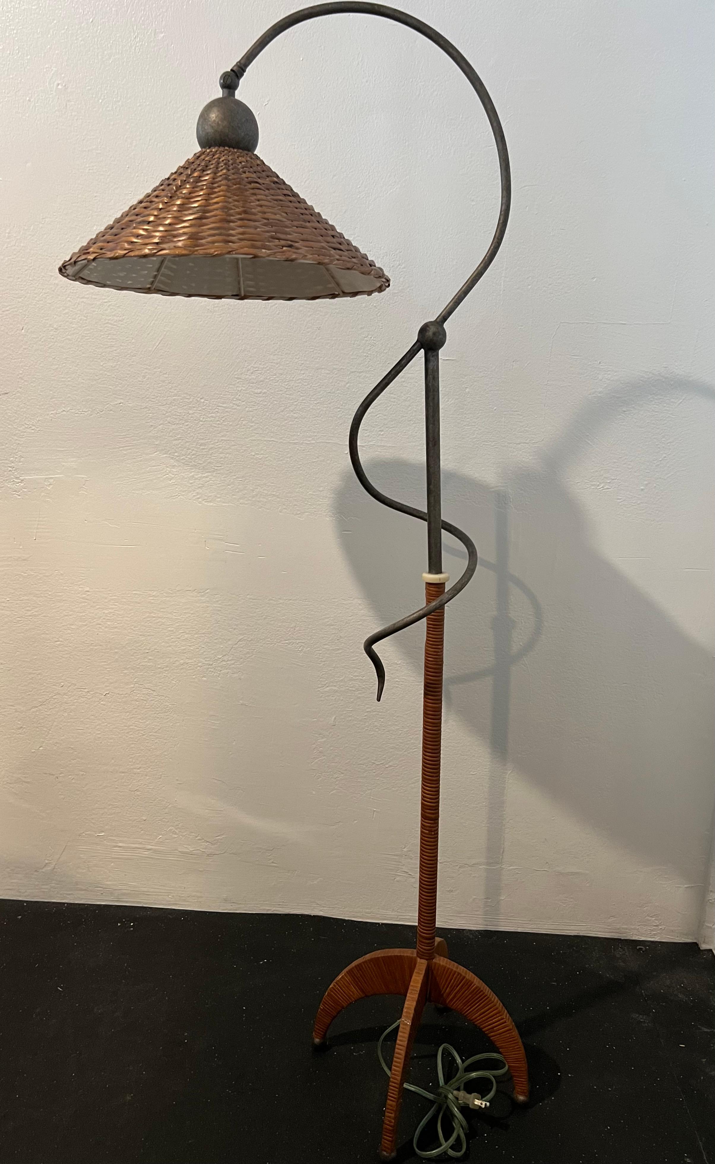 Sculptural cane wrapped floor lamp. Has the ability to telescope and the shade pivots. Original wiring. Some minor imperfections to the wicker and cane (please refer to the photos). Additional photos available upon request.

Would work well in a