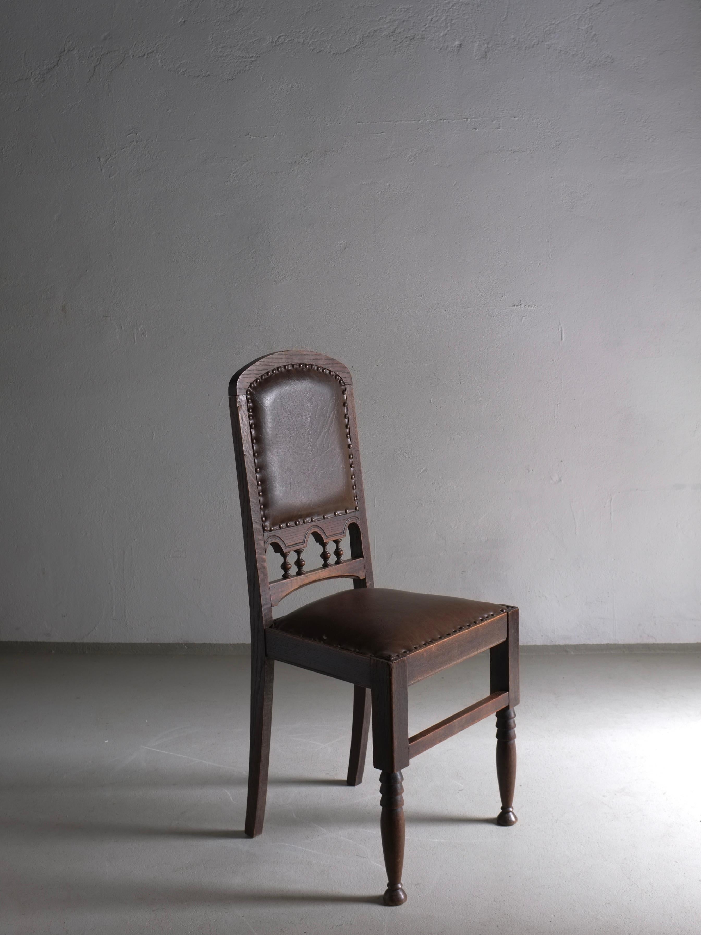 Carved oak side chair with sculptural front legs and artificial leather upholstery. Lightweight.
