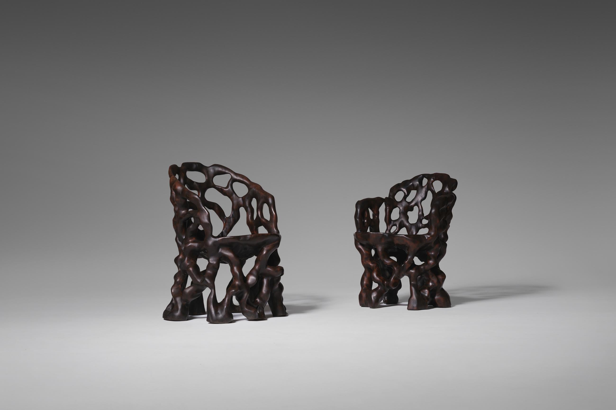 Unique set of sculptural wooden tree trunk chairs, 1970s. The chairs are hand carved out of a solid piece of tropical hardwood. This style of furniture making is a traditional Chinese art and goes back to the 12th century. Very unusual and highly