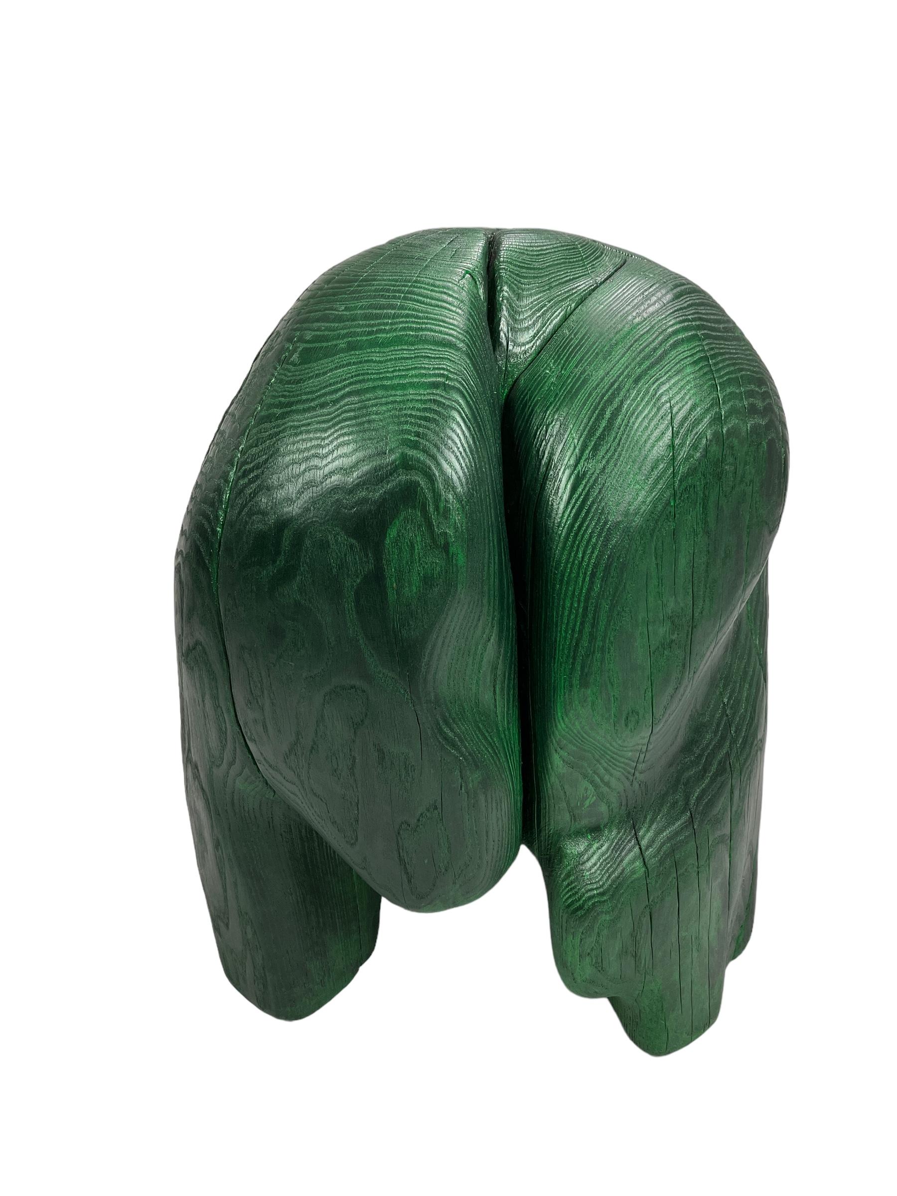 Carved wooden stool from locally sourced elm wood from the lanscape of Småland . Hand carved by master Swedish woodmaker ELAKFORM. 
Painted by hand with a durable acrylic-based colour and finished with an acrylic lacquer. The special green paint