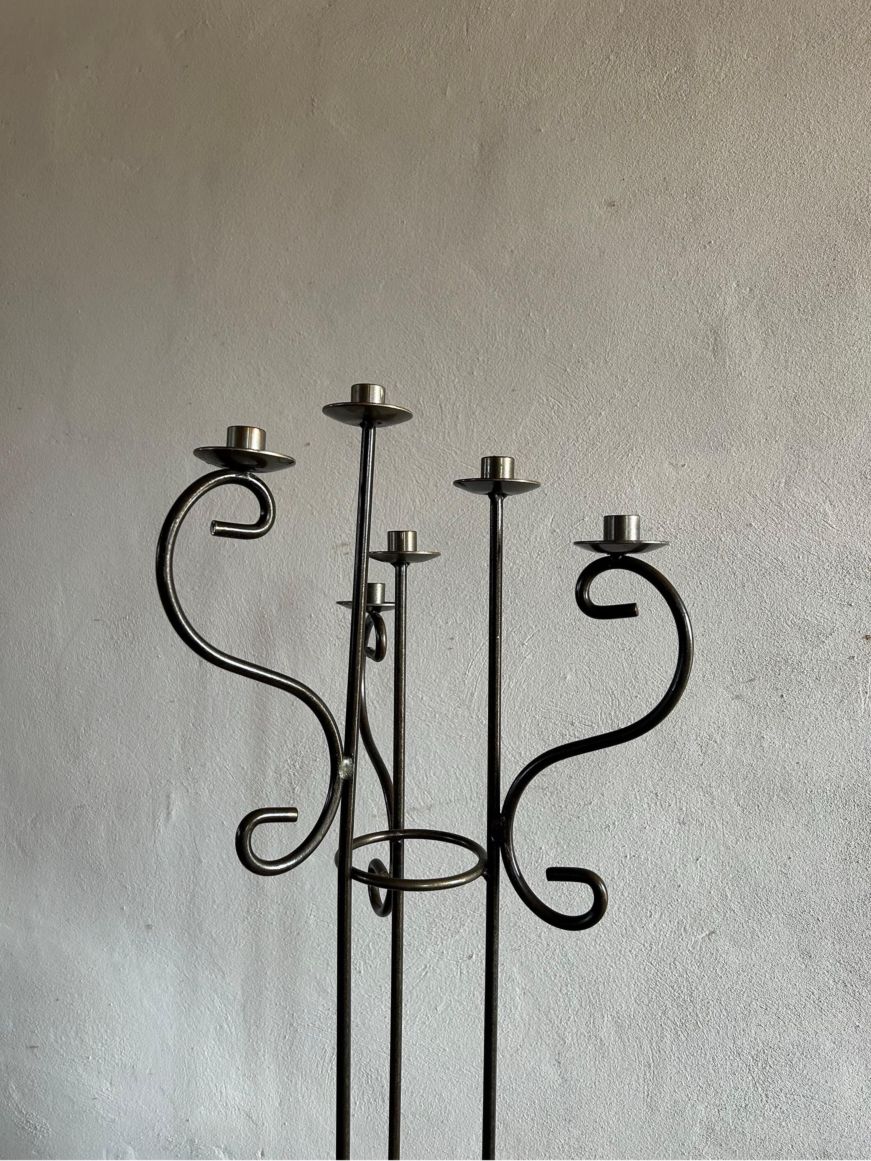 the captivating beauty of this sculptural cast iron floor candelabra, originating from Denmark in the 1970s. Crafted with exquisite attention to detail, this stunning piece effortlessly blends artistry with functionality, making it a striking focal