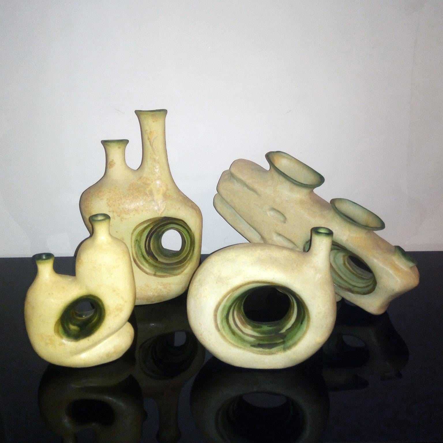 Ensemble de quatre vases en céramique de l'artiste grec Nikos Dazelidis, créés dans les années 1960. 
Ces formes fabriquées à la main reflètent le style caractéristique de Dazelidis : une abstraction organique aux silhouettes fluides, aux contours
