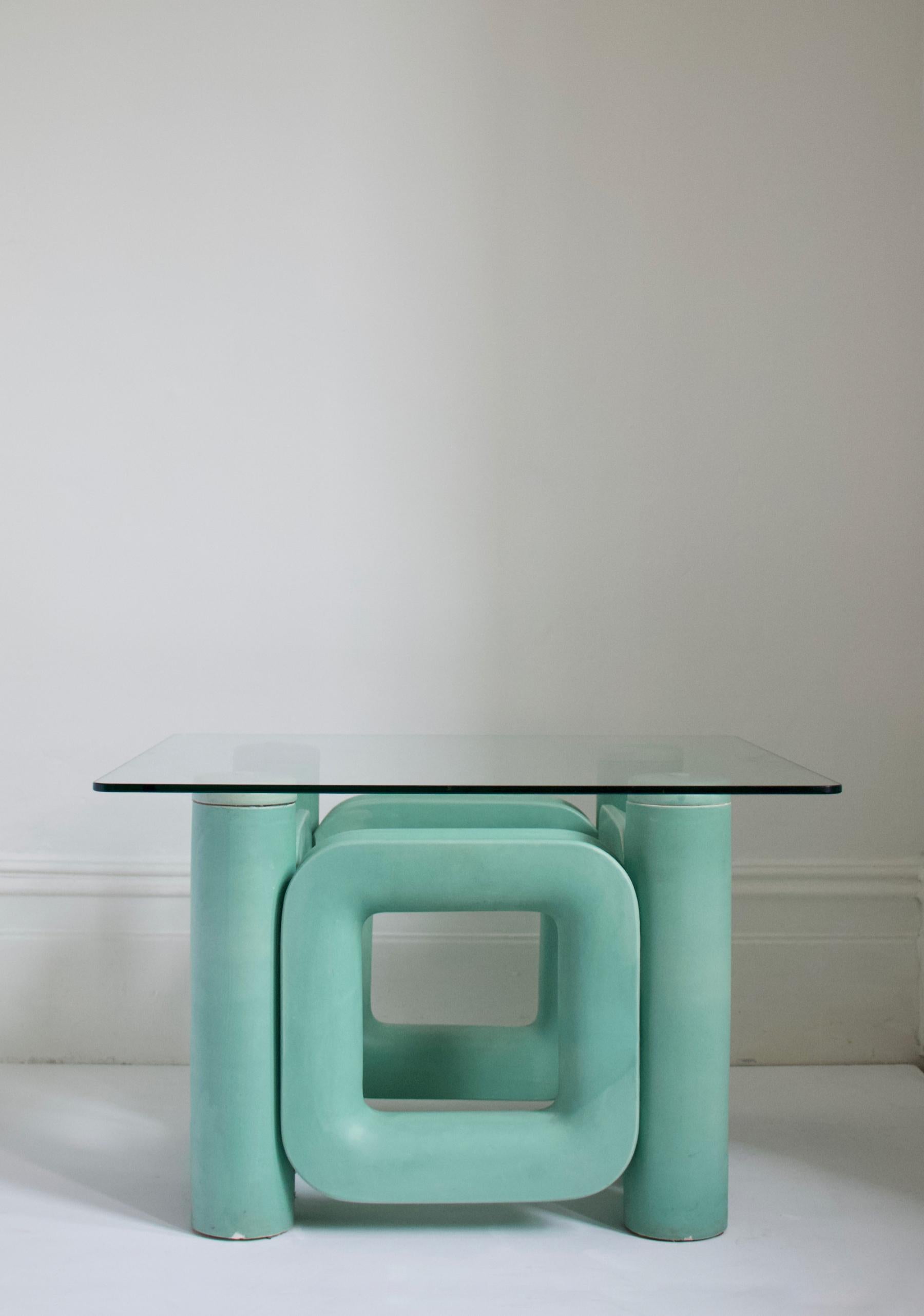 Sculptural ceramic coffee table with blue-turquoise satin glaze, Italy, 1970s

Striking sculptural base, in heavy ceramic, with simple glass top. The glaze is a single colour, with some areas showing slightly thicker or thinner application giving