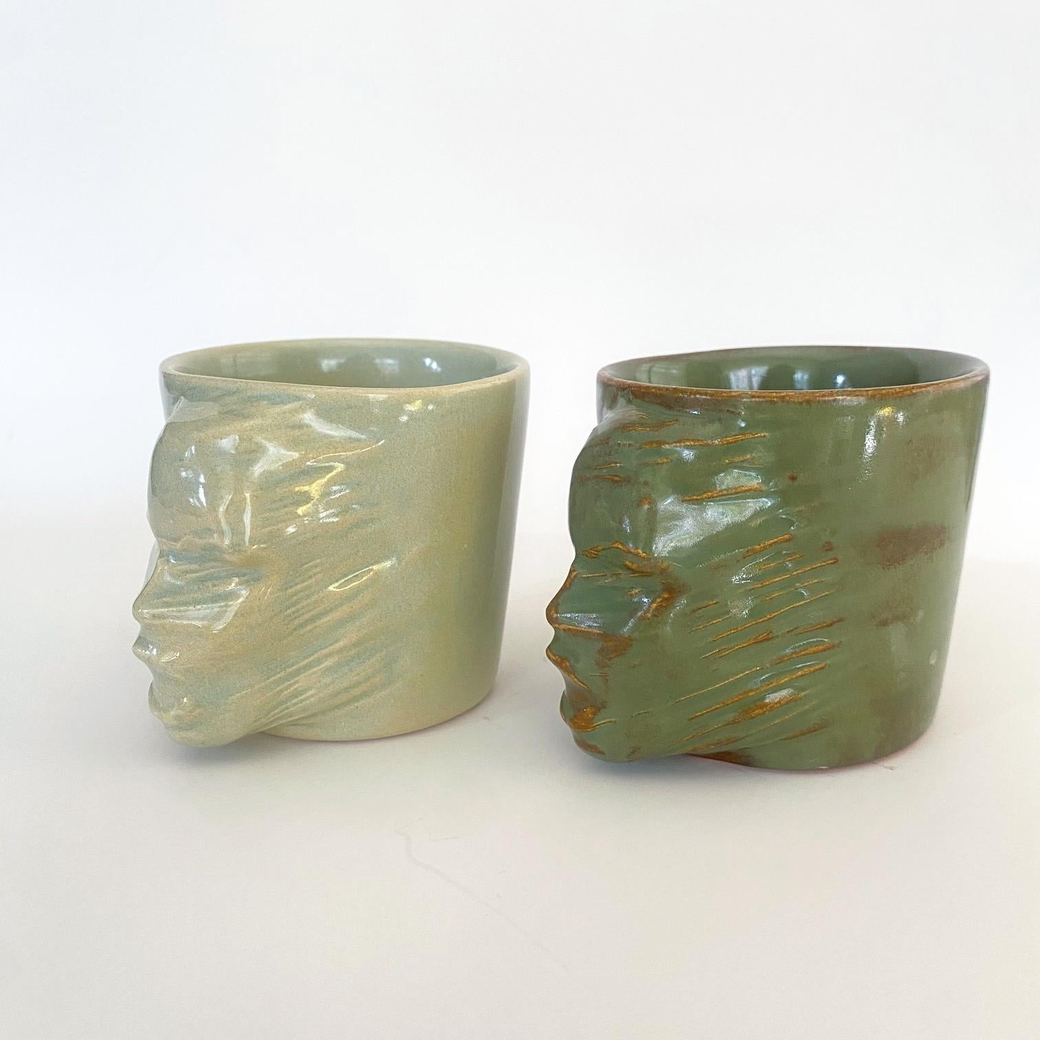 A set of 2 sculptural ceramic cups handmade by the ceramic artist Hulya Sozer. 
Food safe glaze.
Dishwasher safe.

Height: 7cm / Depth: 9cm / Diameter: 7cm
Volume: 120ml
Set includes 2 ceramic cups of 120ml

* Colors may slightly vary due to every