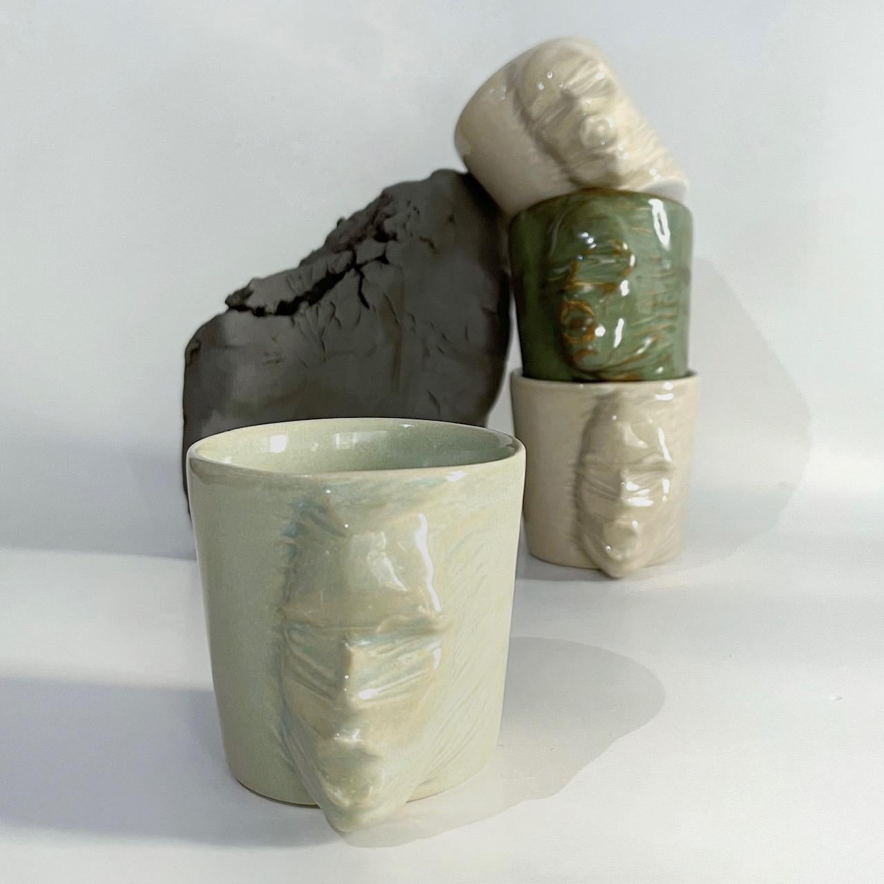 A set of 4 sculptural ceramic cups handmade by the ceramic artist Hulya Sozer. 
Food safe glaze.
Dishwasher safe.

Height: 7cm / Depth: 9cm / Diameter: 7cm
Volume: 120ml
Set includes 4 ceramic cups of 120ml

* Colors may slightly vary due to every