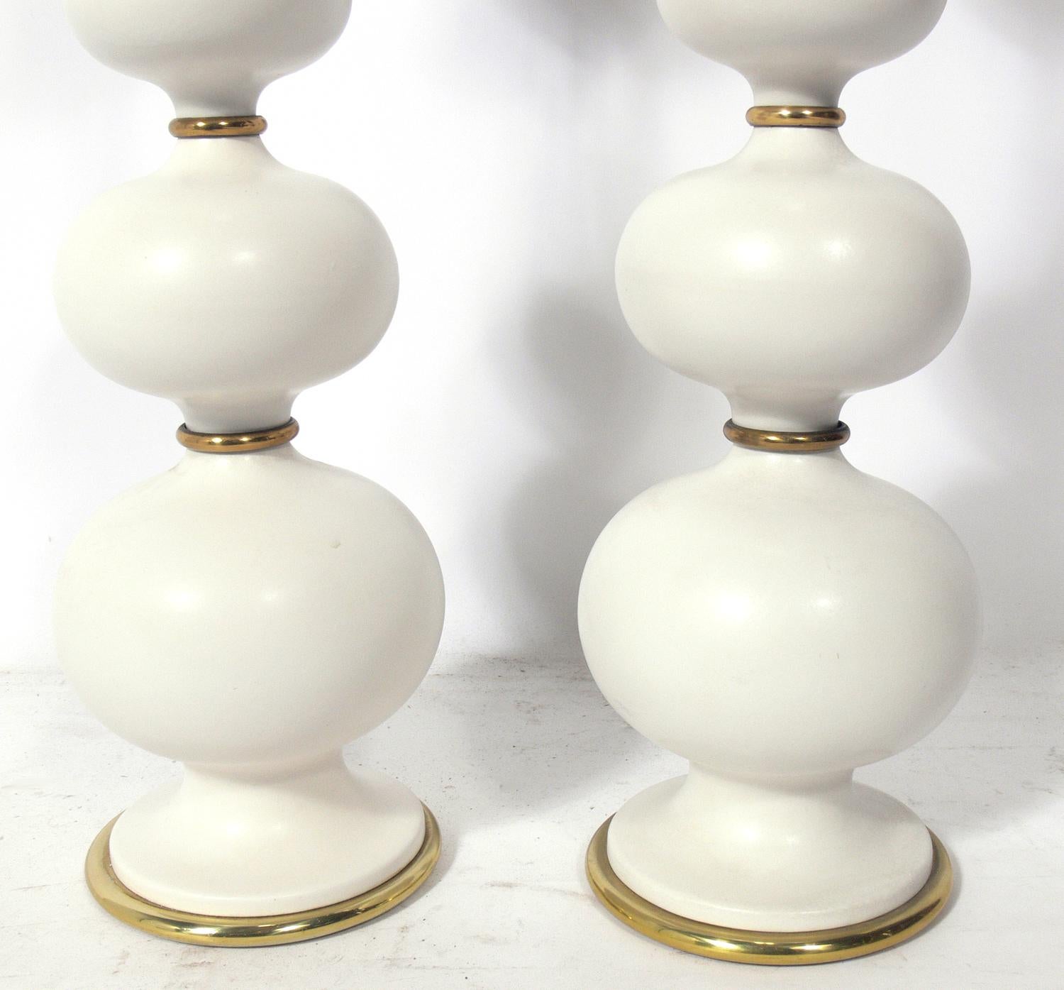 Sculptural ceramic lamps, designed by Gerald Thurston for Lightolier, circa 1950s. They have been rewired and are ready to use. The price noted below is for the pair of lamps, including the shades.