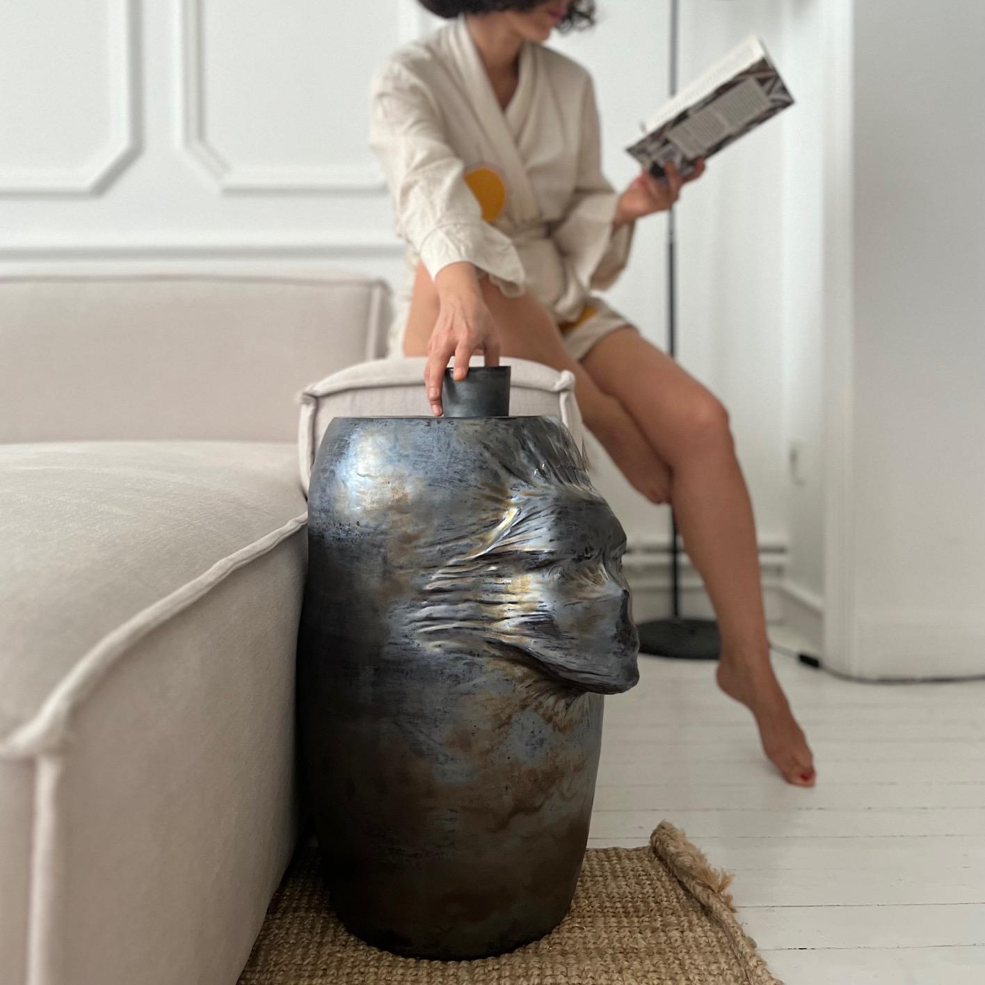 A sculptural ceramic side table handmade by the ceramic artist Hulya Sozer. 
Metallic effect glaze.
Height: 50cm / Diameter: 25cm

Hulya Sozer is a ceramic artist, based in Istanbul, who specialised in figurative sculptures. Her work mostly focuses