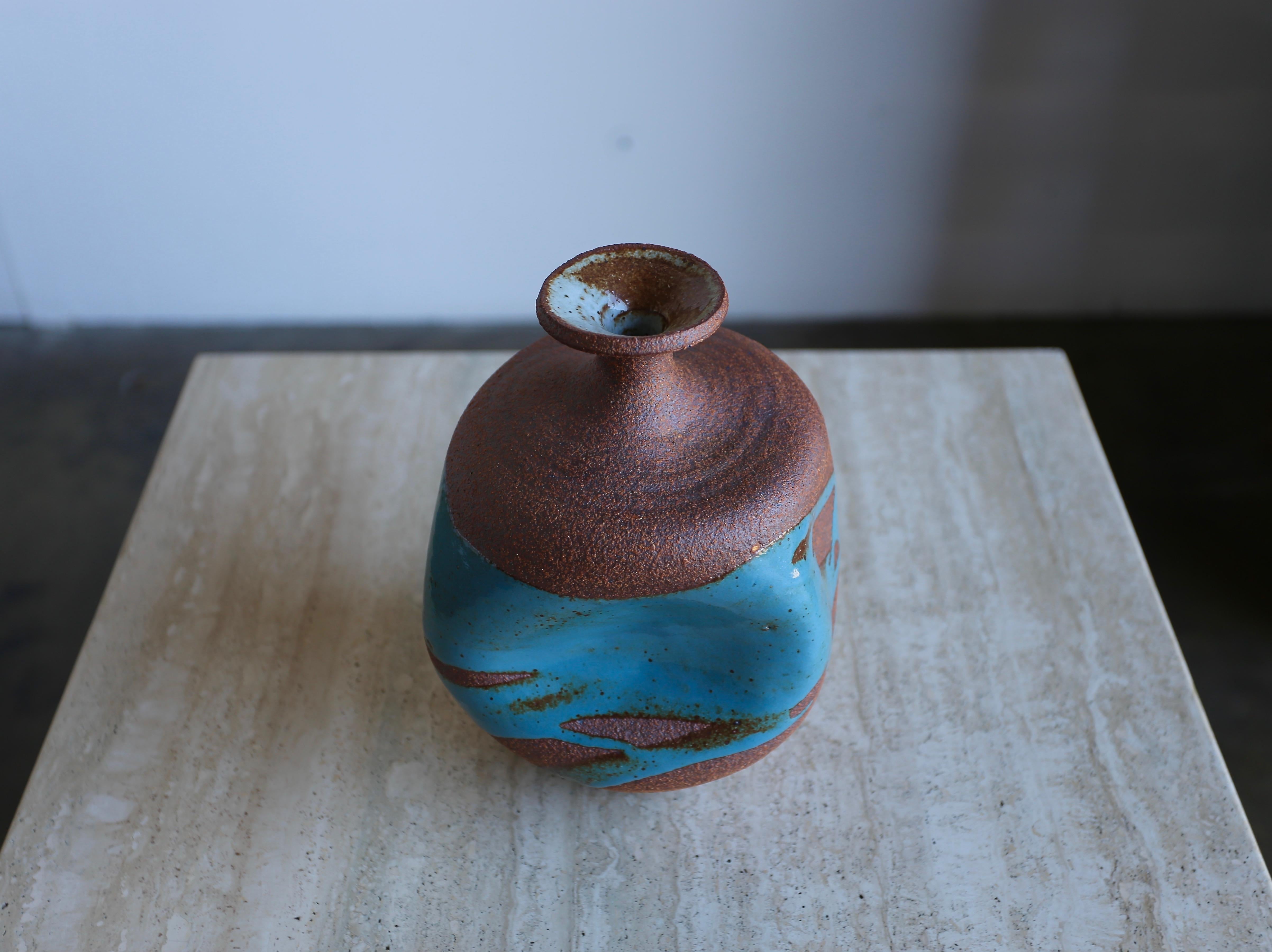 Sculptural ceramic vase by Tim Keenan. Blue drip glaze on a tortured form vase.
