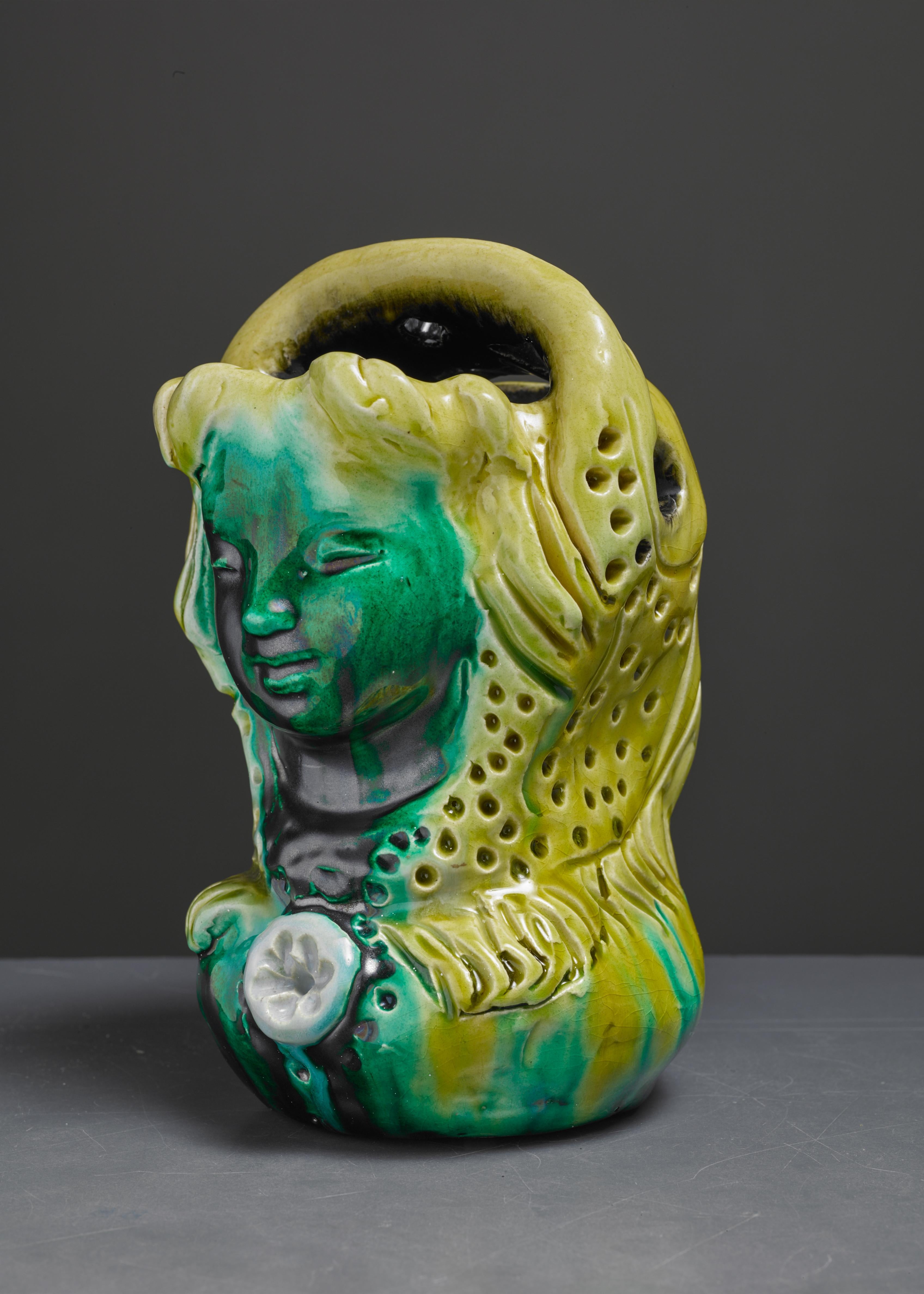 A wonderful ceramic vase of a Madonna's face, with stunning yellow and green colours. In a style reminiscent of George Jouve.
