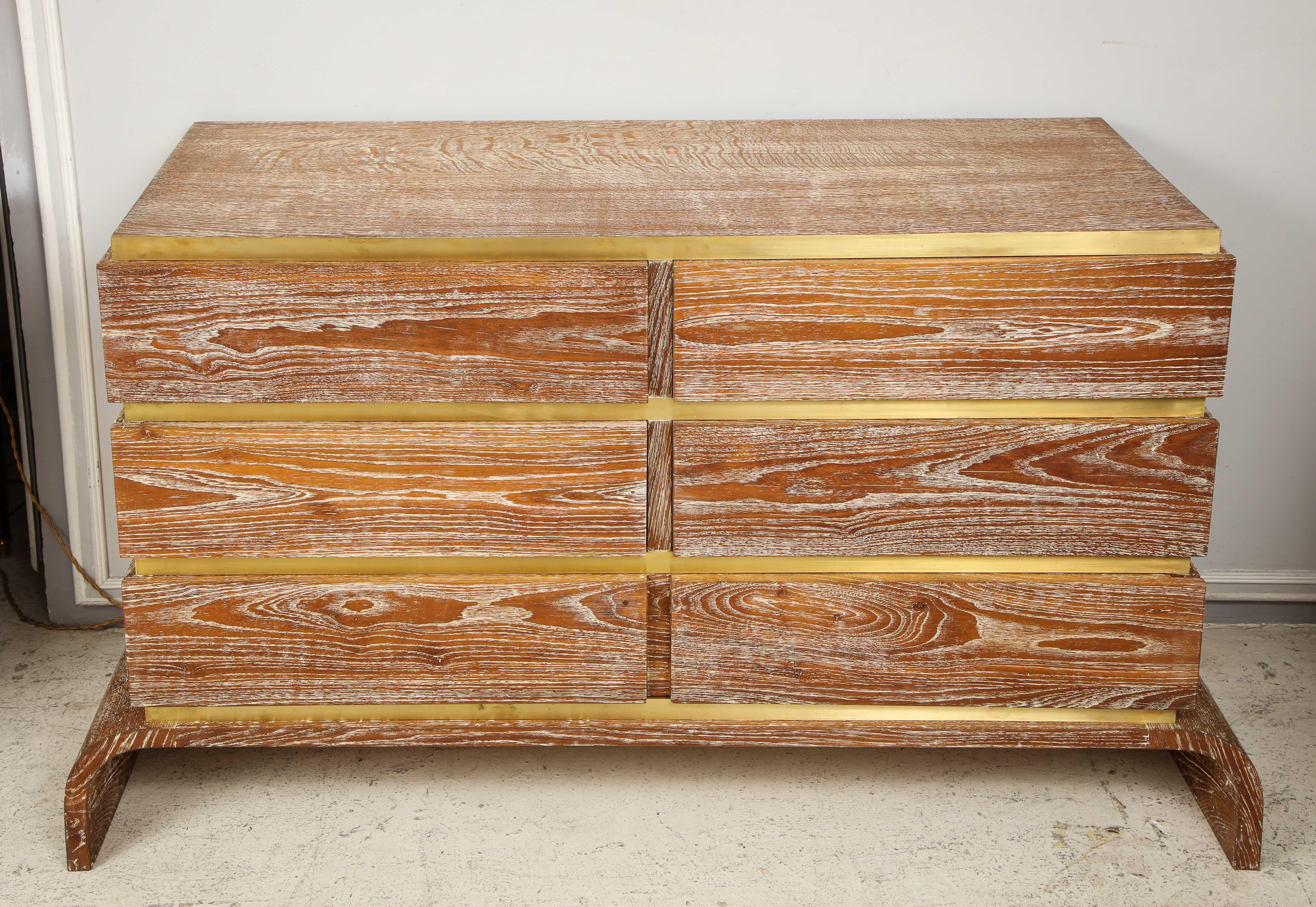 Sculptural cerused oak chest with brass trim. This chest has six drawers.