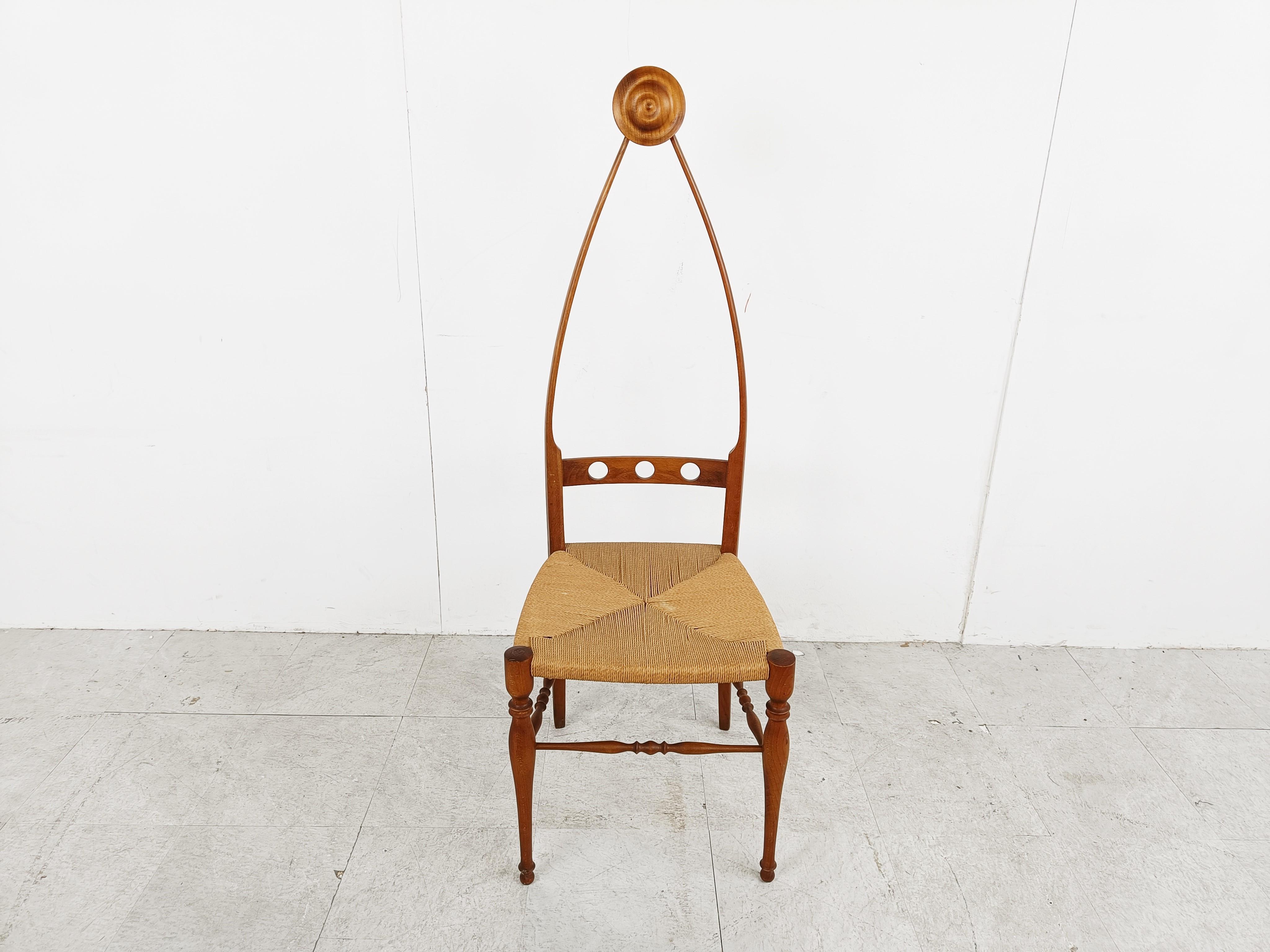 Beautifully crafted sculptural high back chair by Pozzi & Varga.

The very fine and elegant frame is made from walnut and the chair is made of papercord.

Notice the gorgeous curves and detailing on the frame. 

Very decorative chair. 

Very good