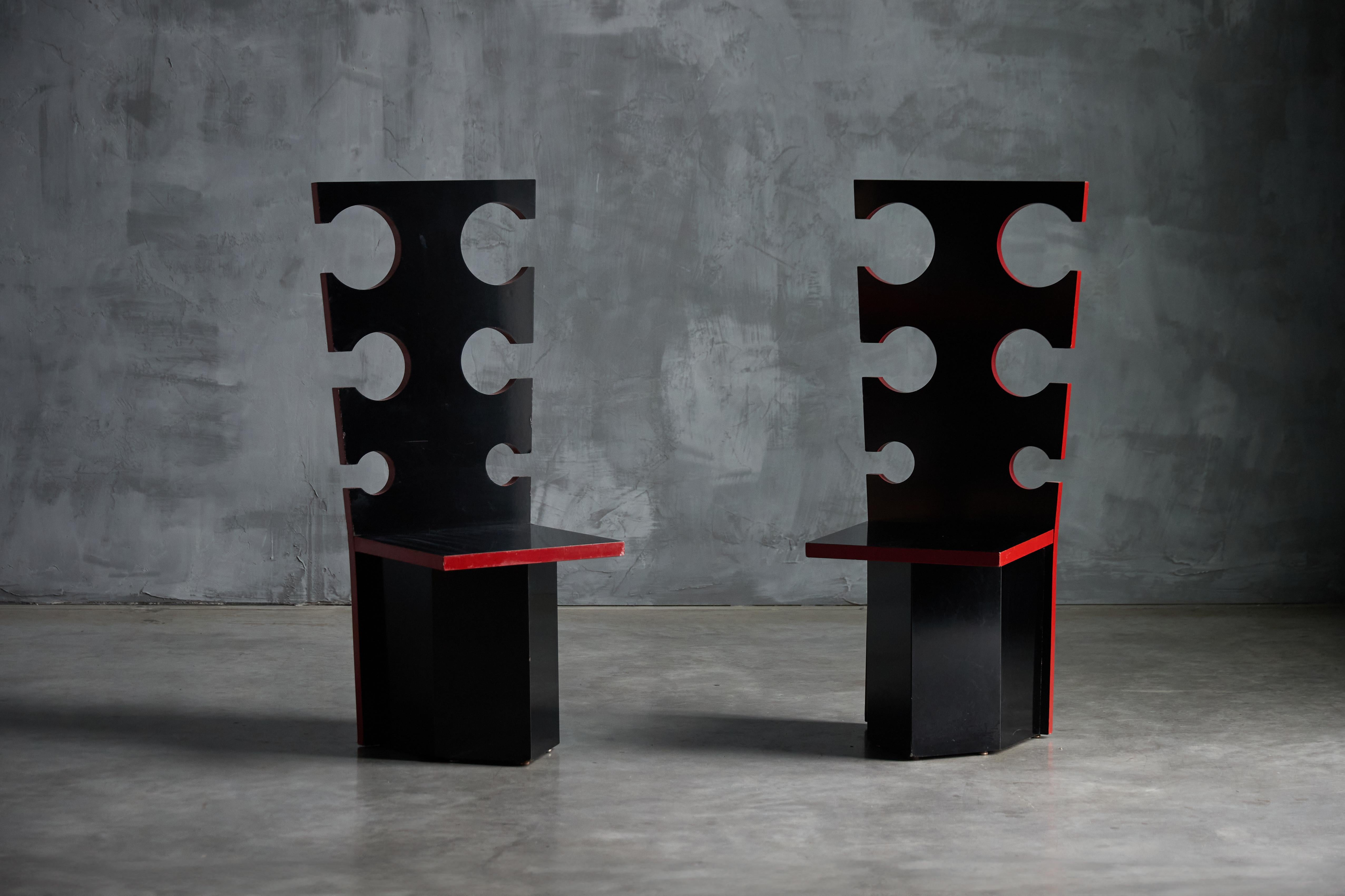 Black lacquered chairs with deep red-edged detailing by Max Papiri - functional art and collectible design. Originally designed on request for the private residence of Mario Sabot, these striking pieces embody a bold architectural presence. The