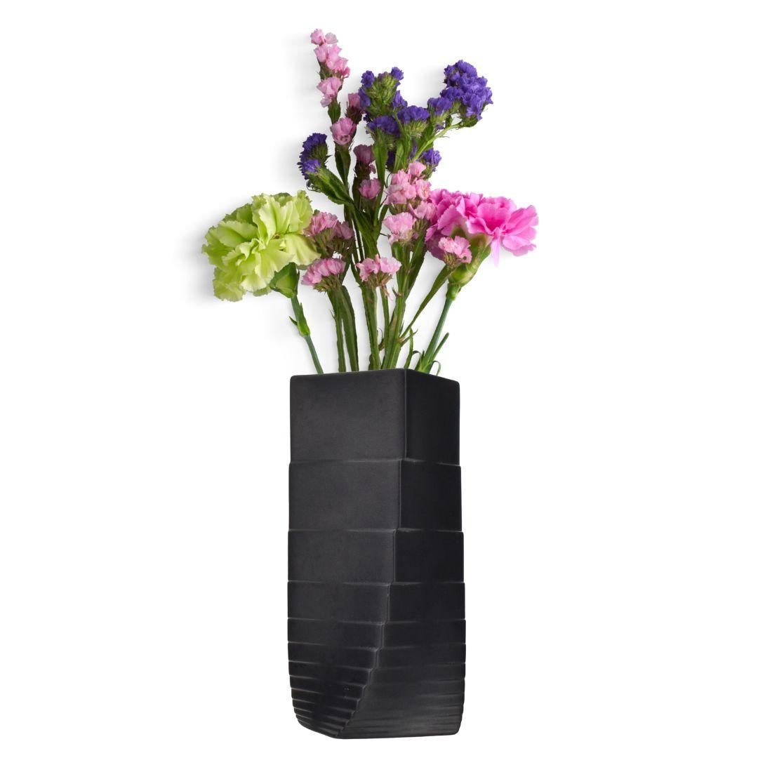 A 1970s black bisque porcelain Op Art vase by Christa Hausler Goltz for Rosenthal. This vase is a prime example of the Op Art movement, which was characterized by its use of geometric shapes, patterns, optical illusions, and the exploration of