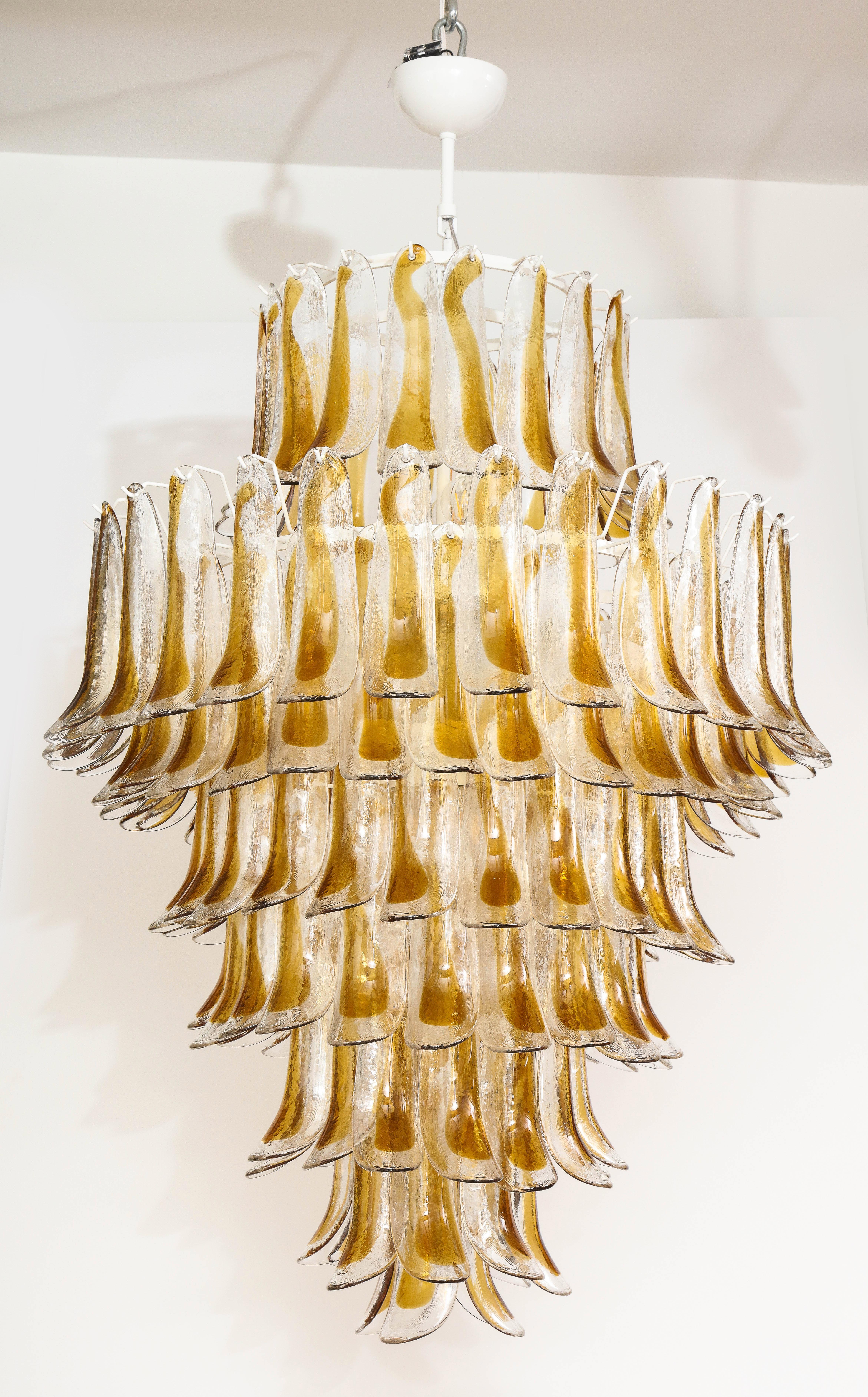 Unique sculptural chandelier consisting of rich toned Amber (gold tone) and Clear, hand-casted Murano glass elements shaped like 