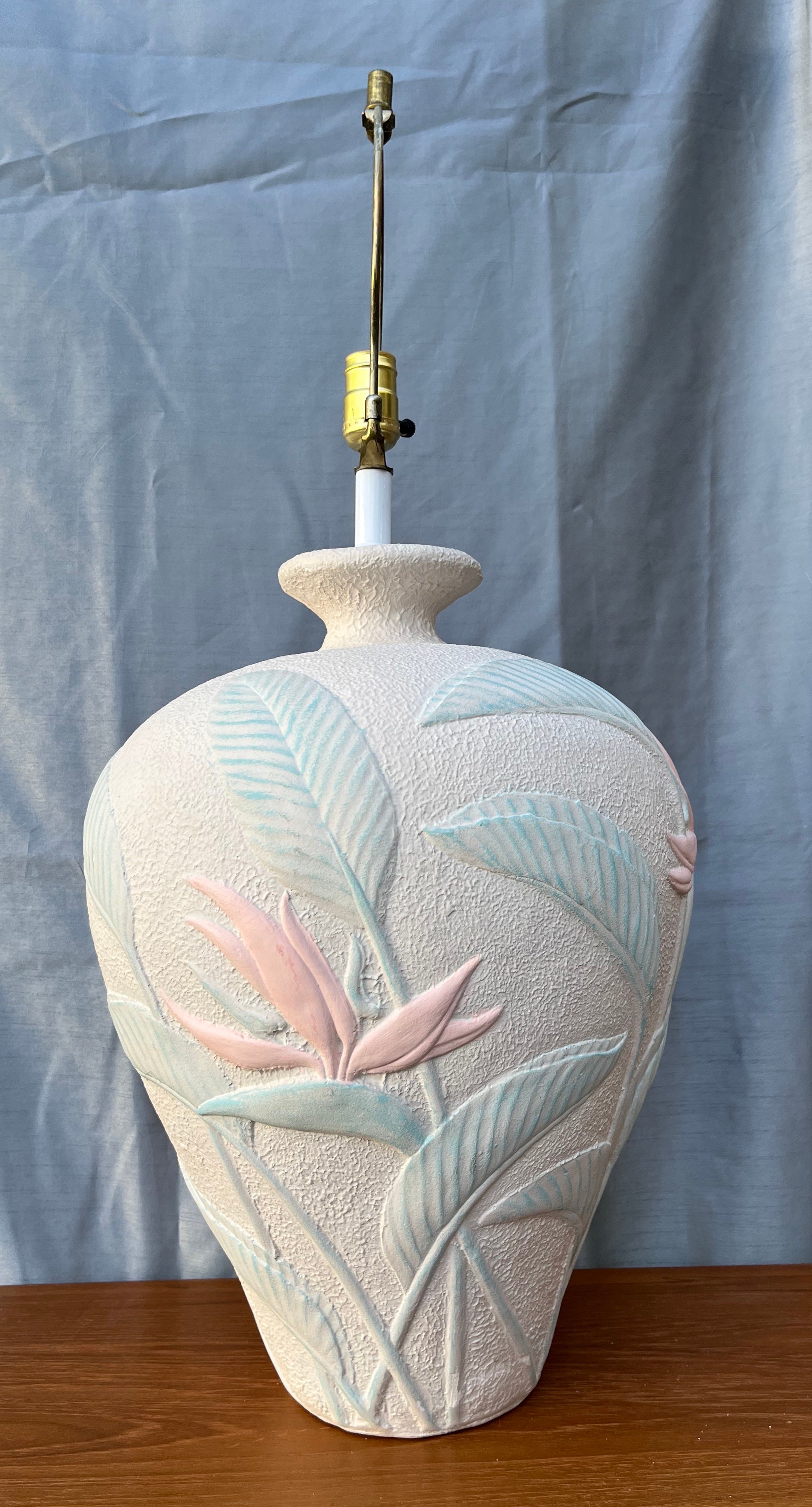Large Vintage Sculptural Coastal Style Bird of Paradise Table Lamp. Circa 1980s
Features a sculptural urn-shaped textured plaster body with Paradise Flower reliefs highlighted with a soft pastel colors
In Excellent Near Mint Original Condition With