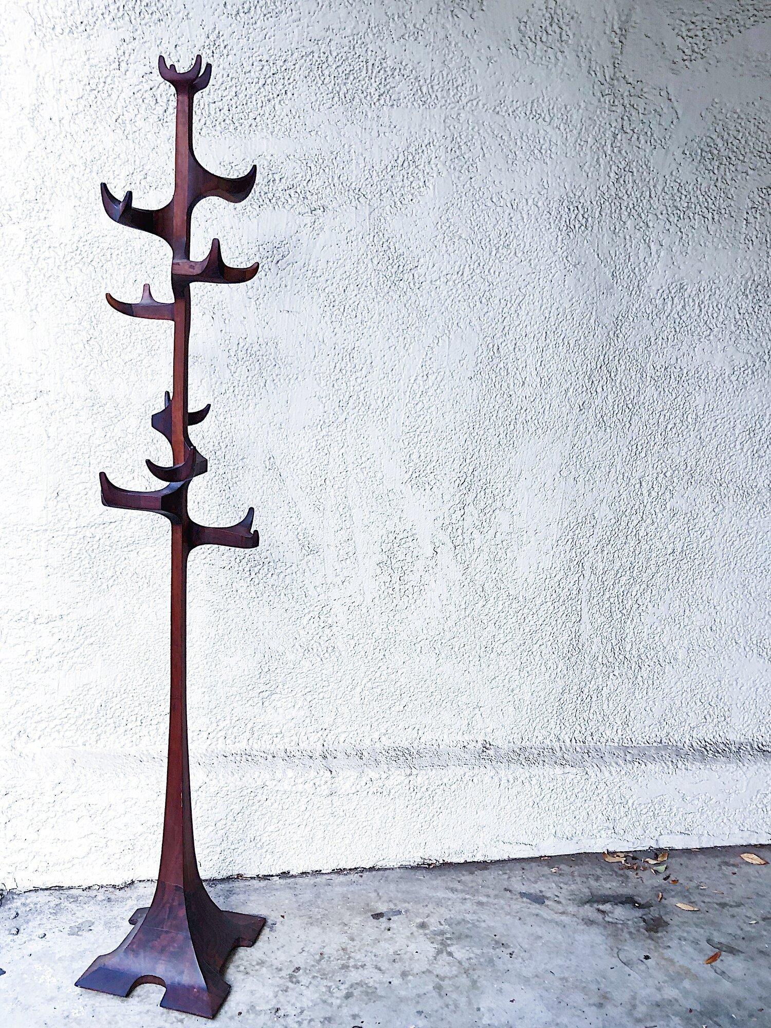 A Mid-Century Modern sculptural coat rack/ hat tree designed by Edward G. Livingston for Archotypo studio, c. 1960s. Handcrafted in solid walnut, “Archotypo LXIX” impressed under the base.  This modern art coat rack is constructed from a series of
