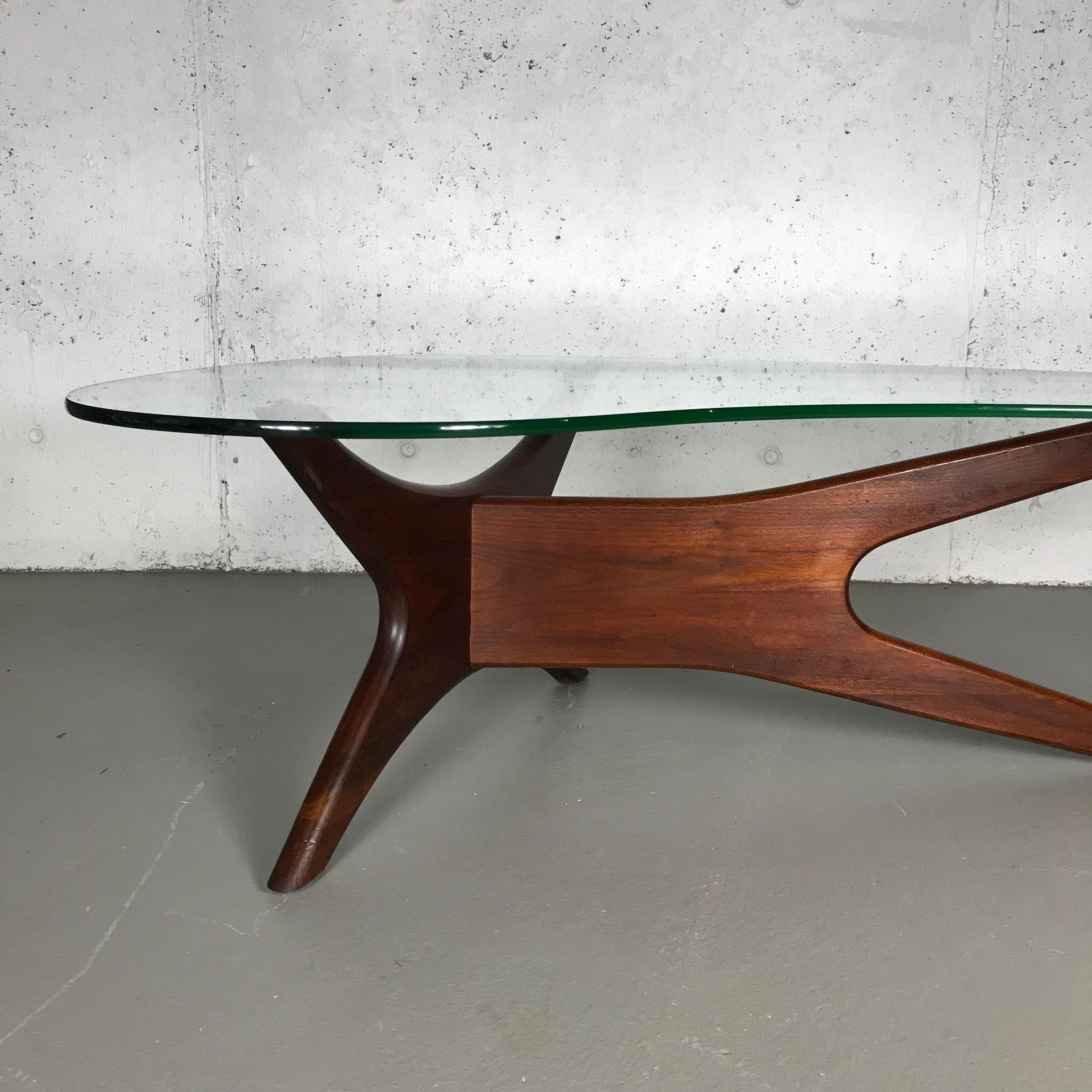 Beautiful sculptural walnut and amoeba shaped glass coffee table by Adrian Pearsall for Craft Associates, 1960s. The table is in very nice original condition with some hard-to-see abrasions to the legs and a few scratches on the glass. Small cluster