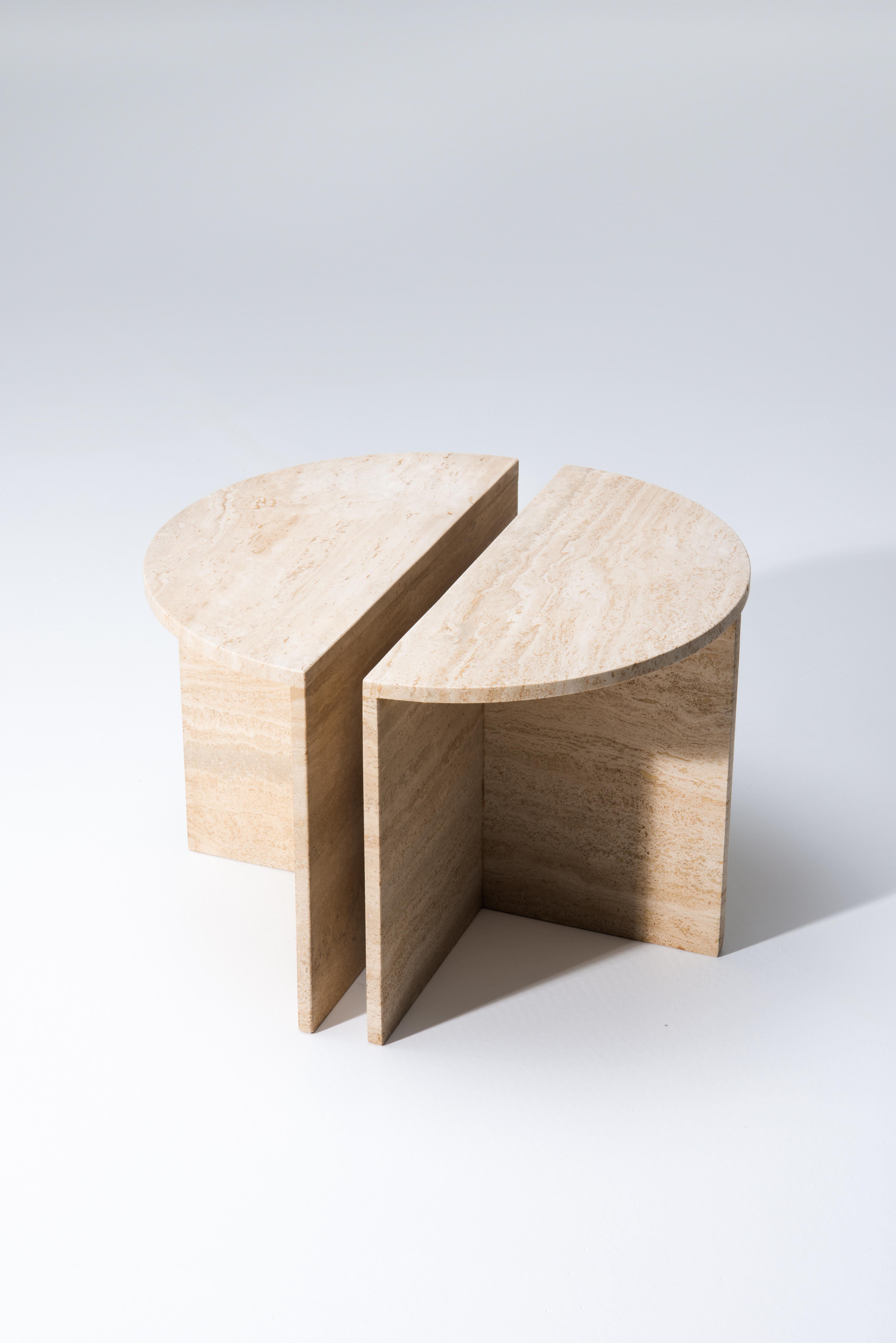 Italian coffee table made in the 70ties in Italy. Consisting of two identical hemispheres of travertine. These can serve together to form a round coffee table or as two separate side tables. 
The two identical tables shows patina and minor signs of