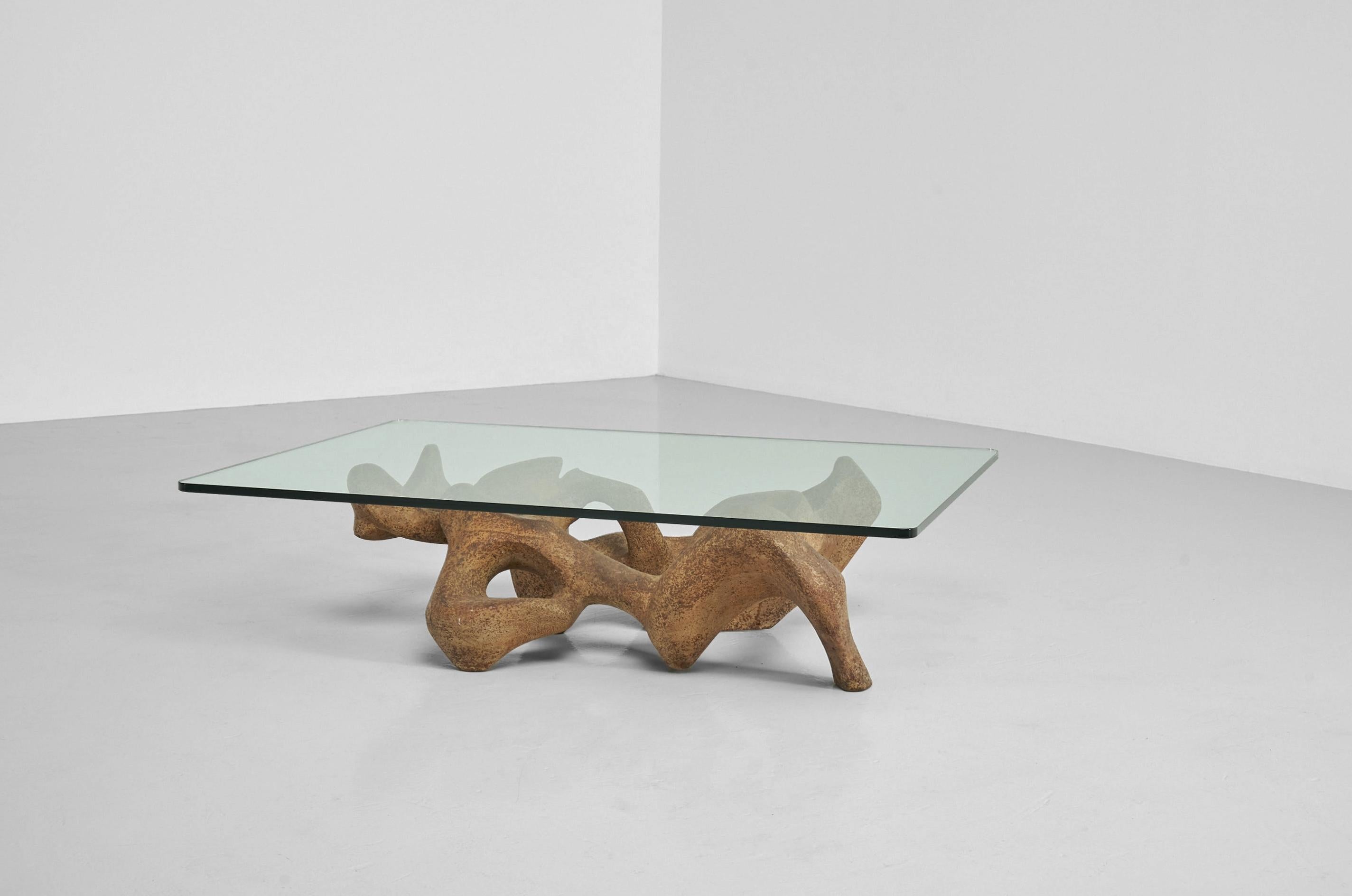 Mesmerizing sculptural coffee table made by unknown artist in Italy in the 1960s. The table looks interesting from every angle, in some ways it looks like a female body which supports the tabletop, from another angle your imagination makes it