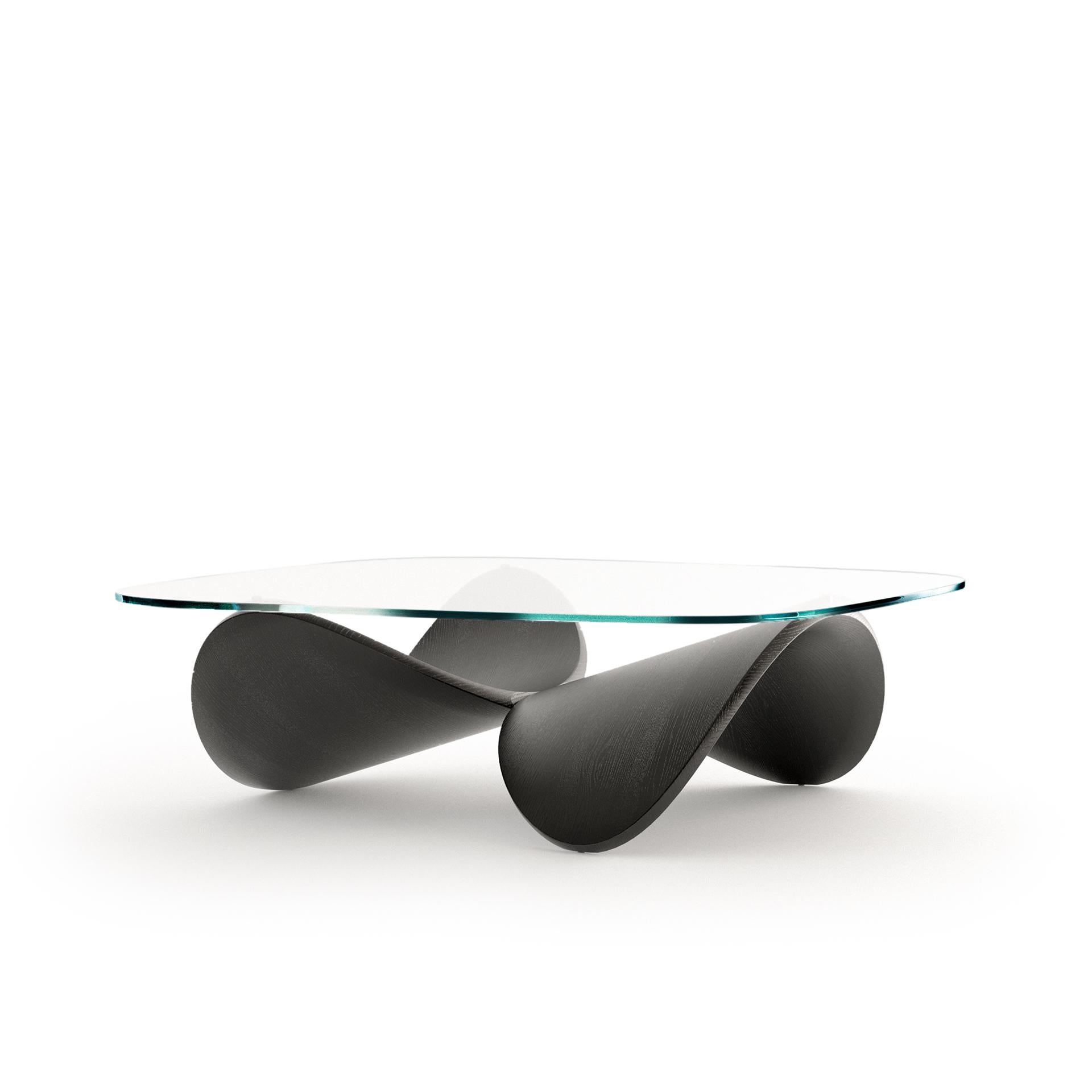 A coffee table made for living spaces that are looking to express uniqueness and a distinctive character. As a piece it is both furniture and sculpture. Once in a room, it expands the spacial quality of the interior by offering new perspectives and