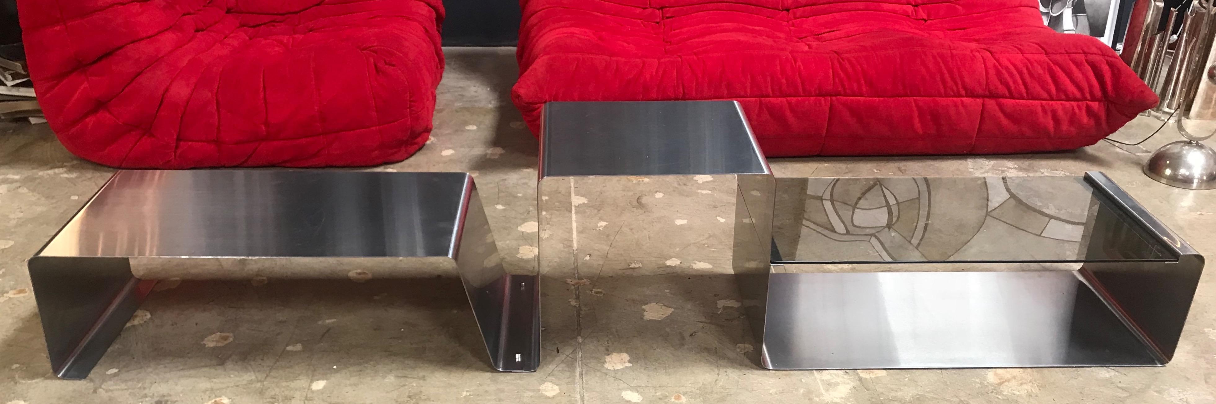 This rare and unique coffee table is made of three modular pieces: 
two in chrome metal and one with a glass top.
Unique sculptural shape: a piece of Art in a living room.
 
