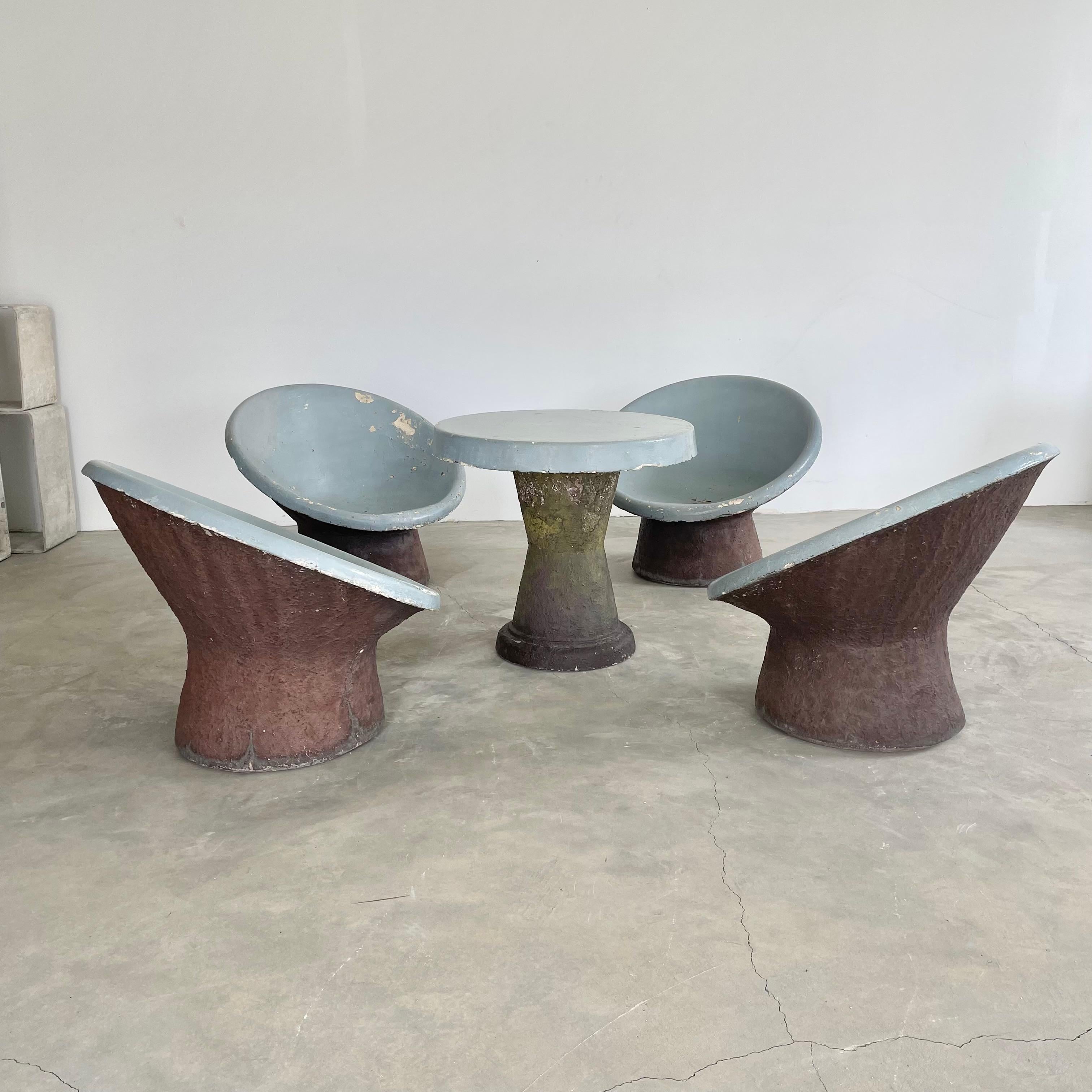 Incredible outdoor table and chairs set consisting of four chairs with a matching table, all made of solid concrete in Switzerland, circa 1960s. The seats of the chairs as well as the table top are hand painted in a medium gloss grey paint with the