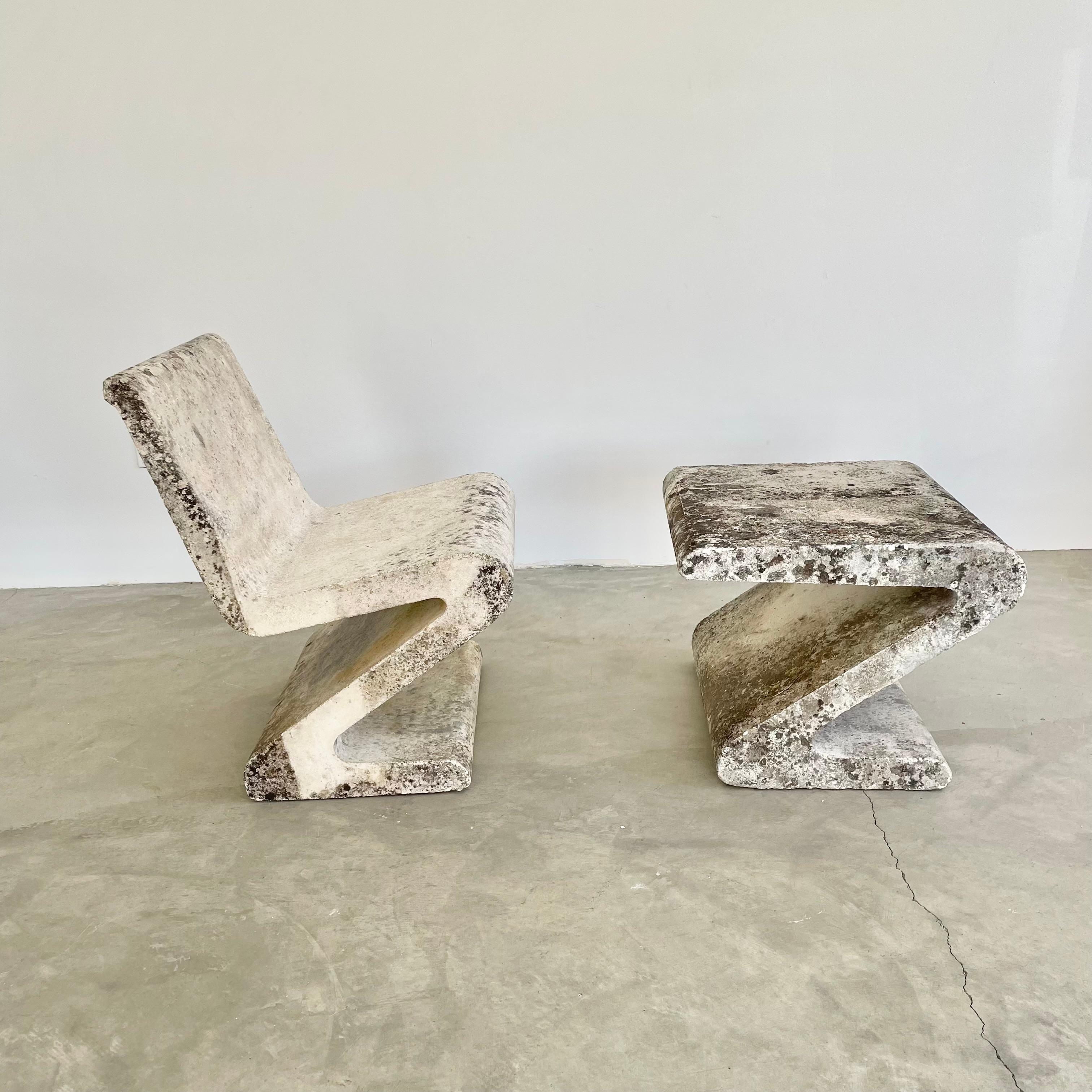 Substantial concrete zig zag chair with a matching side table. Stunning presence and design. Industrial steel rebar runs inside the concrete reinforcing the chair and table giving them extra strength. Reminiscent of the Rietveld ‚Zig Zag chairs,