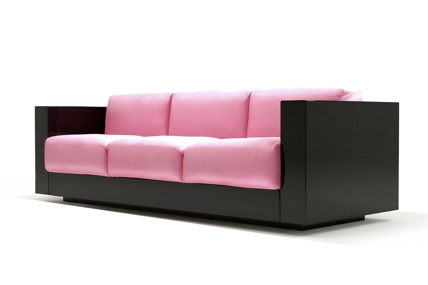 In a world longing for transformation, the Revolución Sofa doesn’t whisper change—it embodies it. With a fearless palette of bubblegum pink velvet against a deep black lacquer frame, it balances softness and structure, rebellion and repose. Every