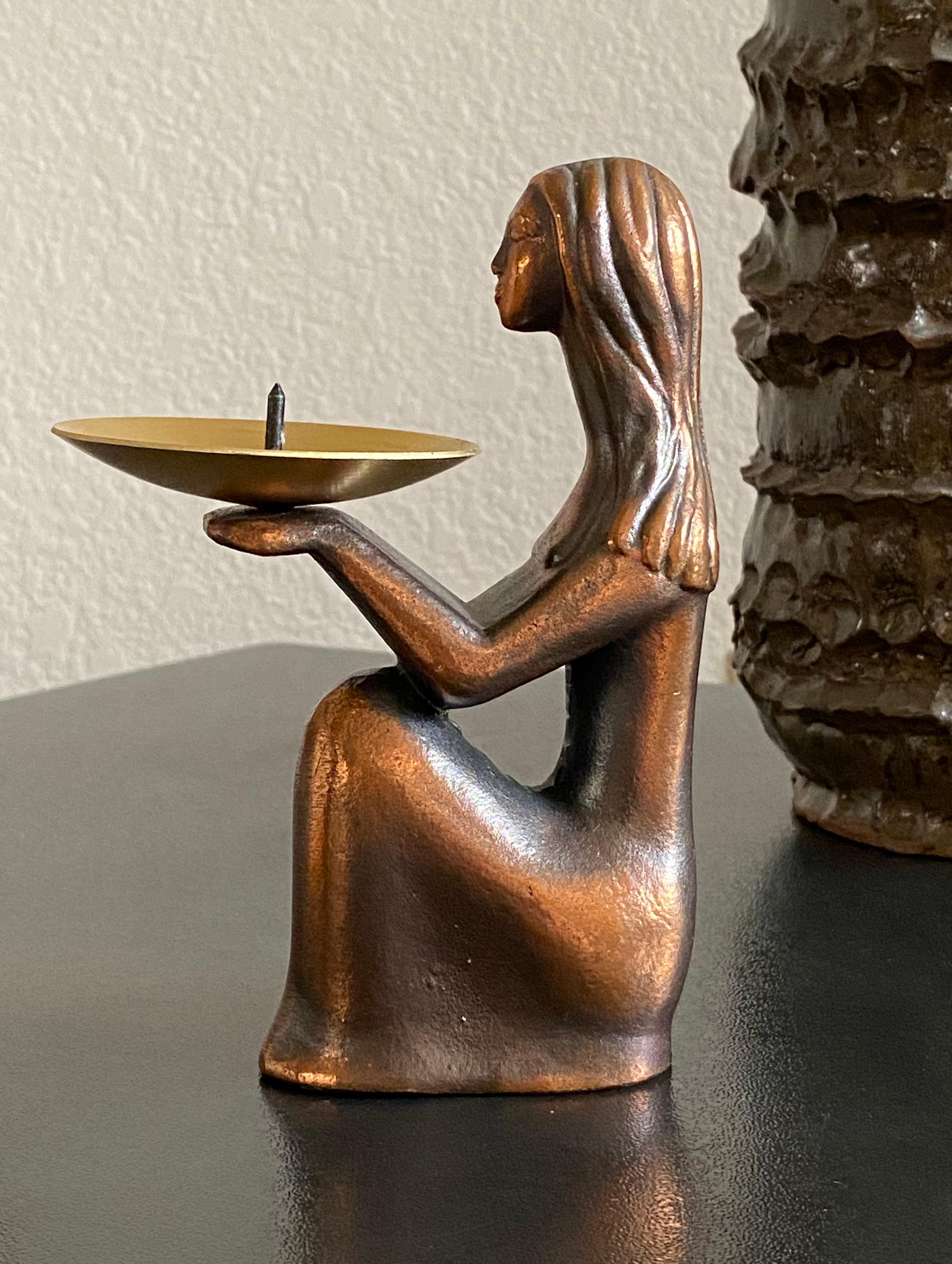 Former Soviet era (1970s) candle holder…artist-titled ‘Good Night’ with original label to base in Russian. Nice hand feel and weight on copper-finished form. 

The feminine figure displays a peaceful, graceful stance and expression. We sense an Art