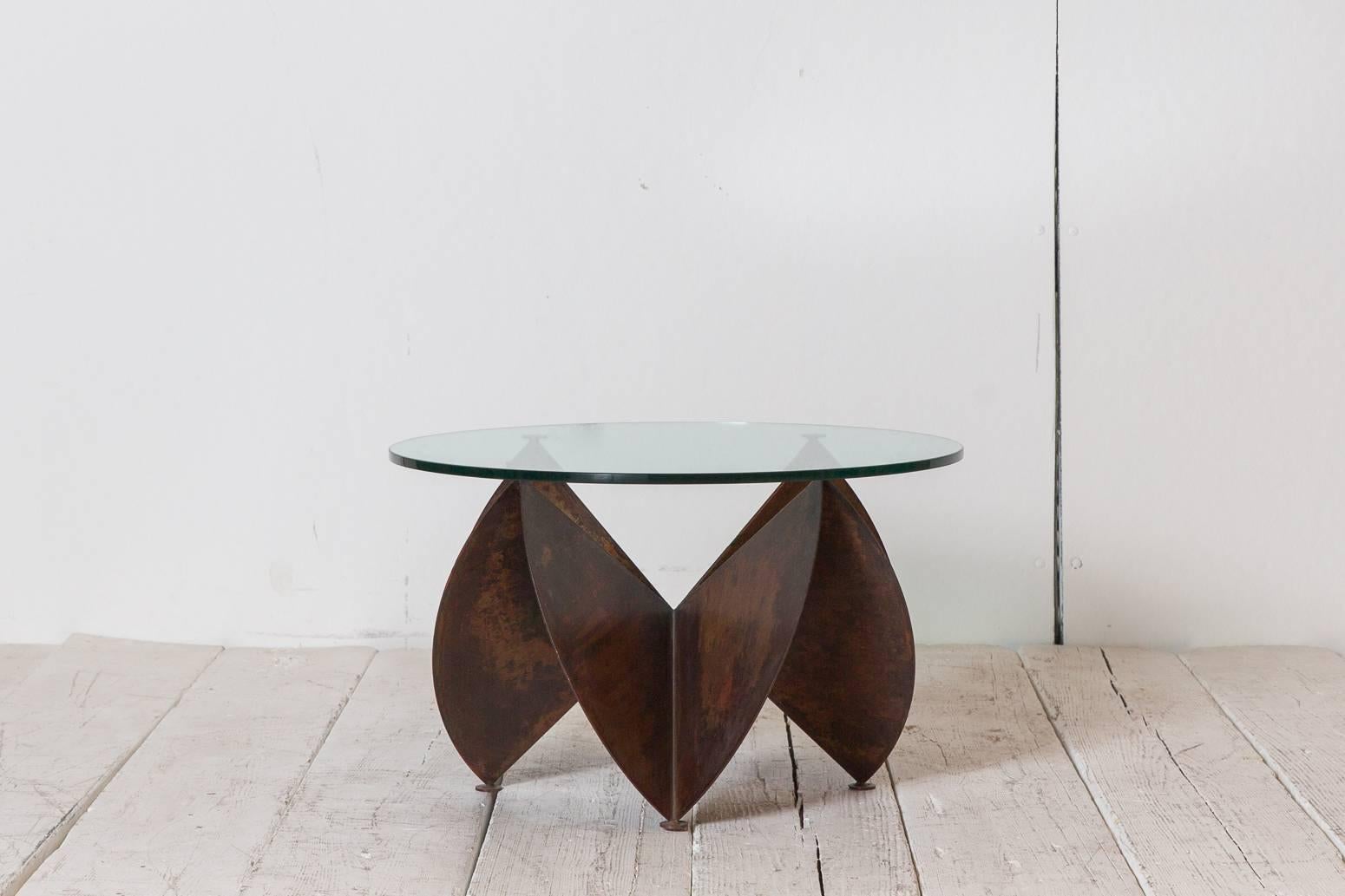 Sculptural copper side table with round glass top. Base measures: 21